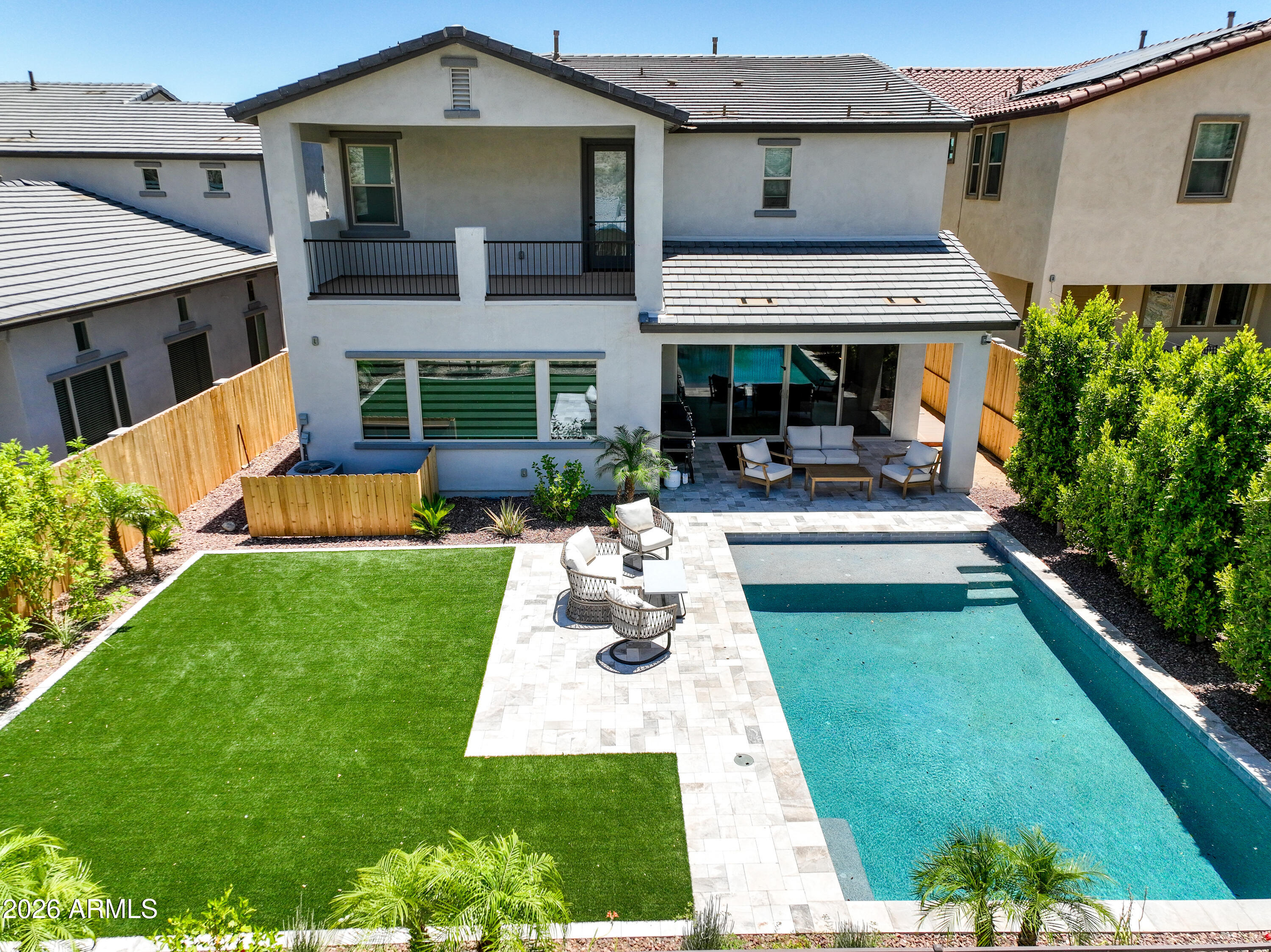 Built by Capital West in 2023, this home features the popular Elevate floor plan and has been used exclusively as a personal vacation retreat, so it still feels brand new. It has over $375,000 in builder upgrades, highlighted by an extended kitchen with a massive executive island, quartz countertops, and premium LVP flooring. The owner's suite is a private getaway, complete with a freestanding soaking tub, walk-in shower, and its own private second-story covered deck. Outside, the backyard has been transformed into a true desert oasis, showcasing a custom Shasta Pebble-Tec pool with a baja step, professional hardscape & landscaping, plus wood accent walls that give it that resort feel. This is the perfect spot to take in the mountain views and beat the summer heat.