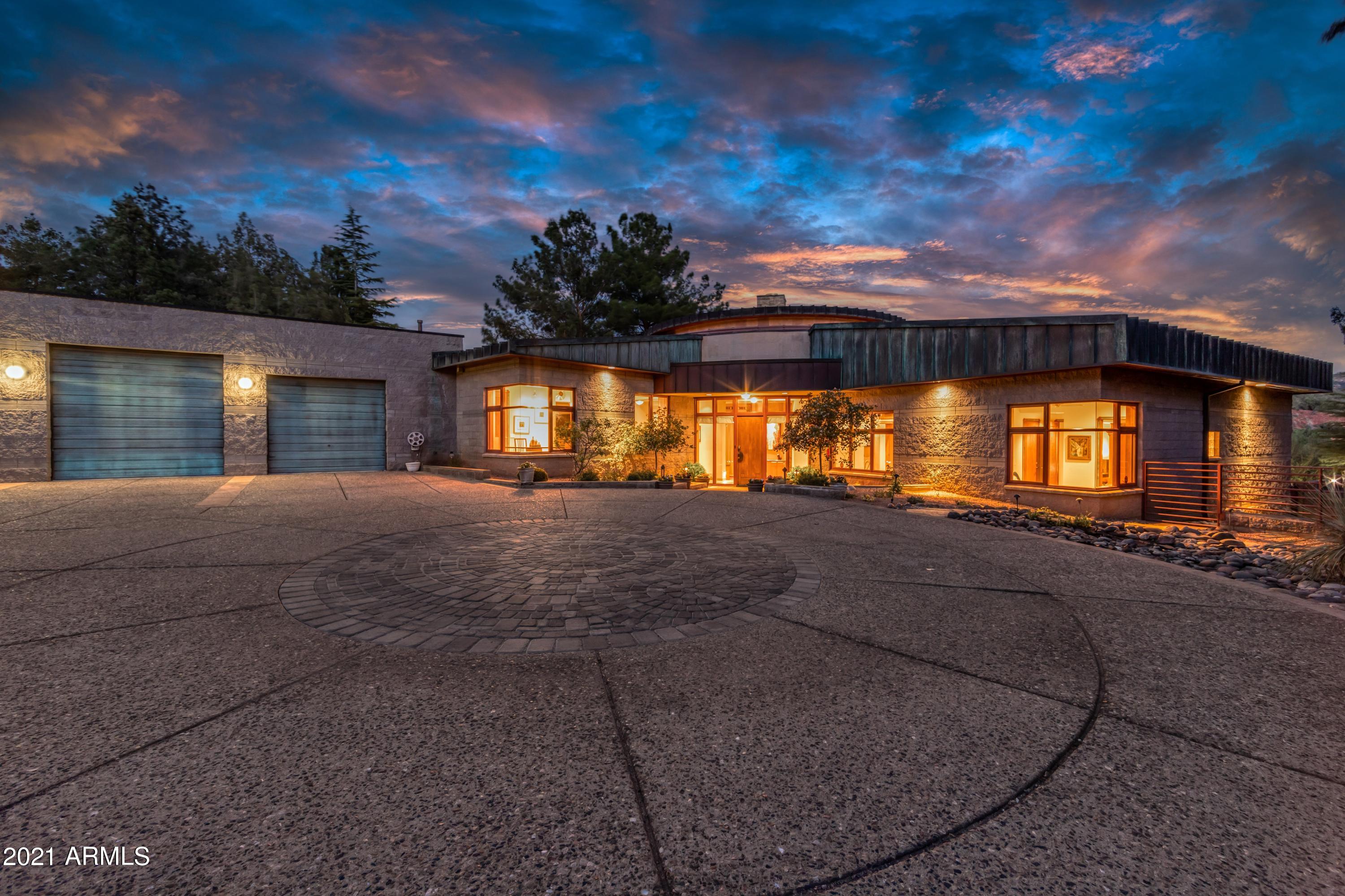 Cliff Castle is a private estate on Oak Creek. Access the lower lawn, creek and cascading cliff face waterfall via the 4 person tram or stairway. Built on a one level semi-circle, the central circular living area offers fine acoustics and can comfortably entertain friends and family. Two en-suite bedrooms and two others that share a bath. Private office. Gracious outdoor living areas include a negative edge pool and spa, generous patio seating options and an observation deck for viewing the incomparable red rock landscape and stargazing. Wood and copper trimmed doorways throughout the home are only one example of the unique details in this stunning Design Group creation built by Phil Morris. Whole house sound system/bose speakers. Big nature abounds in a glamorous retreat close to town.