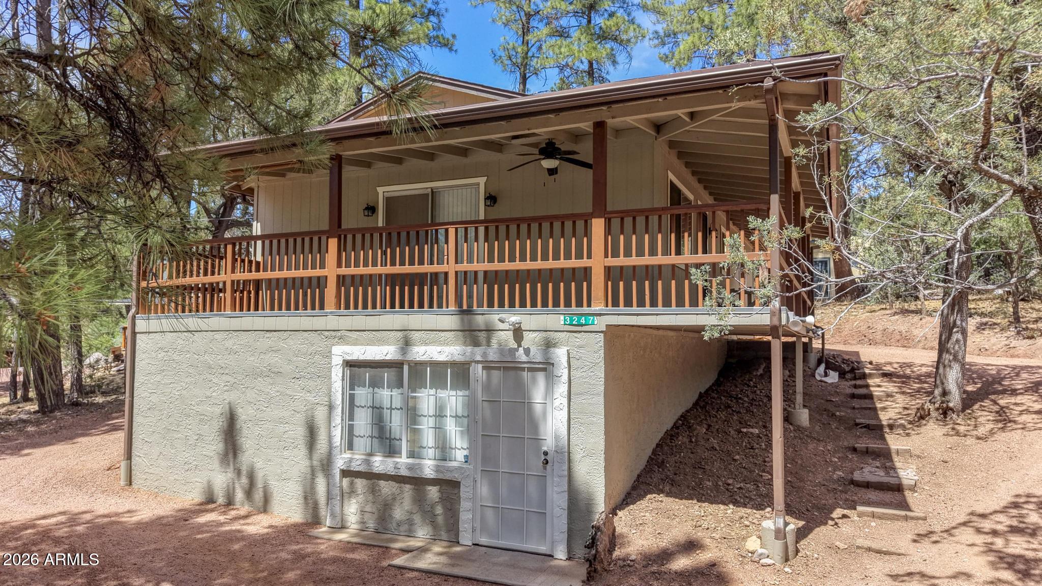 Charming remodeled 2-bedroom, 2 bath cabin, designed for modern living. Sitting on double lot that give you .44 acres, two-story walk-out basement fully finished, wood laminate flooring throughout, cozy wood burning stove on both levels that enhance a warm and inviting space. The kitchen showcases a spacious dining bar that comfortably seat six, alongside a beautiful kitchen with stylish backsplash and butcher block countertops.  Walk-in pantry adds convenience, housing a refrigerator and stackable washer and dryer. New ceiling fans throughout, split system downstairs, brand-new HVAC unit, large deck that wraps around two sides, a tuff shed for extra storage in the backyard.  This cabin combines rustic charm with modern conveniences! Don't miss out on this one!