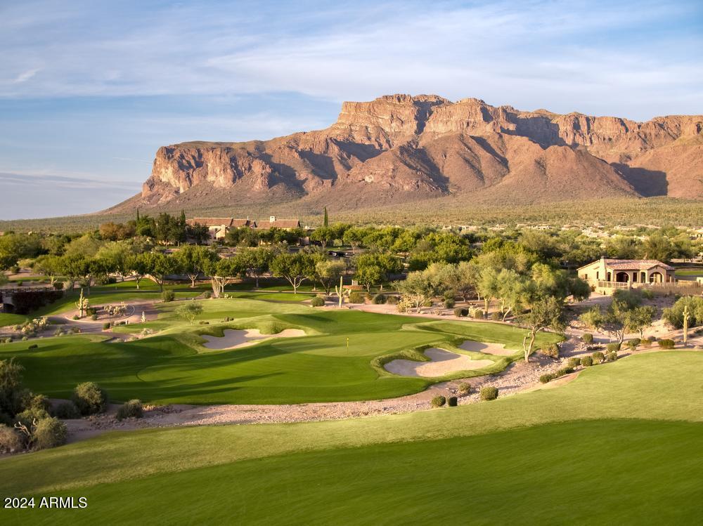 LOCATION, LOCATION, LOCATION!
FABULOUS GOLF COURSE HOMESITE, STUNNING SUNSETS AND MOUNTAIN VIEWS are waiting for you in Superstition Mountain Golf & Country Club! This well over half acre lot includes plans designed by a Frank Lloyd Wright trained architect in the charming and exclusive Wildflower Village, a boutique enclave of just 9 gorgeous homesites. This prime property in Wildflower Village sits on a spectacular viewpoint with expansive views of two fairways on the beautiful Prospector Golf Course. IMPORTANTLY, this sale INCLUDES A FULL SET OF HOA APPROVED PLANS very thoughtfully designed to appreciate the lighting, privacy, city lights, golf and mountain views. You'll save more than a year of architectural planning and reviews. You can start construction in early 2025, why wait? This is an easy build, level homesite which will save you time and money during construction. ALSO, this homesite is conveniently located within a scenic walk to the clubhouse, driving range and sports club. Superstition Mountain is a private, guard gated community with two 18 hole Jack Nicklaus designed golf courses, a fabulous 50,000 sf clubhouse with fine dining, bar and outdoor patio dining, bocce ball, pickleball, tennis, fitness center with classes, club events and activities, walking trails, nearby hiking and all located within 35 minutes of Sky Harbor Airport. Golf and Social memberships are optional and under separate agreement.