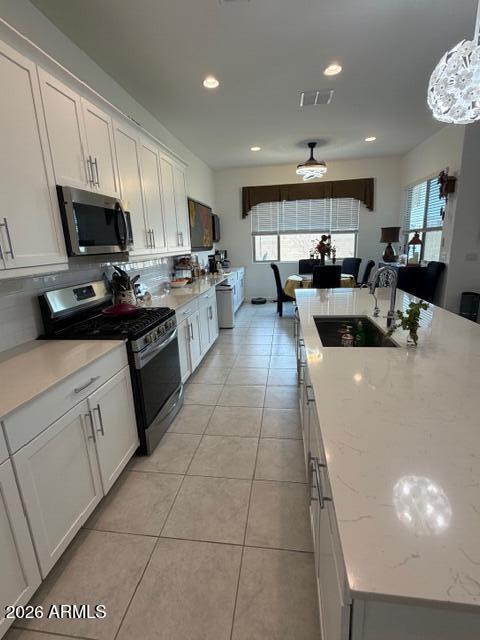 Beautiful highly upgraded Lennar NEXTGEN home with a full private entry 1 bedroom attached guest suite including a full kitchen and single car direct entry garage with its own private outdoor space. The main home has 3 very nice size bedrooms with 2 full baths and a beautiful, finished backyard with a custom stone waterfall synthetic grass, and built in bar area. Off to the side is a very serine garden area with citrus and herbs ready for your gourmet meal preparation. The main home has a secluded primary bedroom with an upgraded primary bath with separate dual vanities, fully tiled shower, and a huge walk-in closet.  There are two other nice-sized secondary bedrooms and a full bathroom on the front side of the home away from all the living areas. The Main kitchen has extended cabinetry. with matching counters that flow into the dining area and an OVERSIZED island. Both homes have plenty of additional recessed lighting with custom fans and light fixtures. Custom gated entry to both front doors at the front of the home. Professionally installed pet door enters into a small secluded and safe dog run in the back yard.  Come see today!