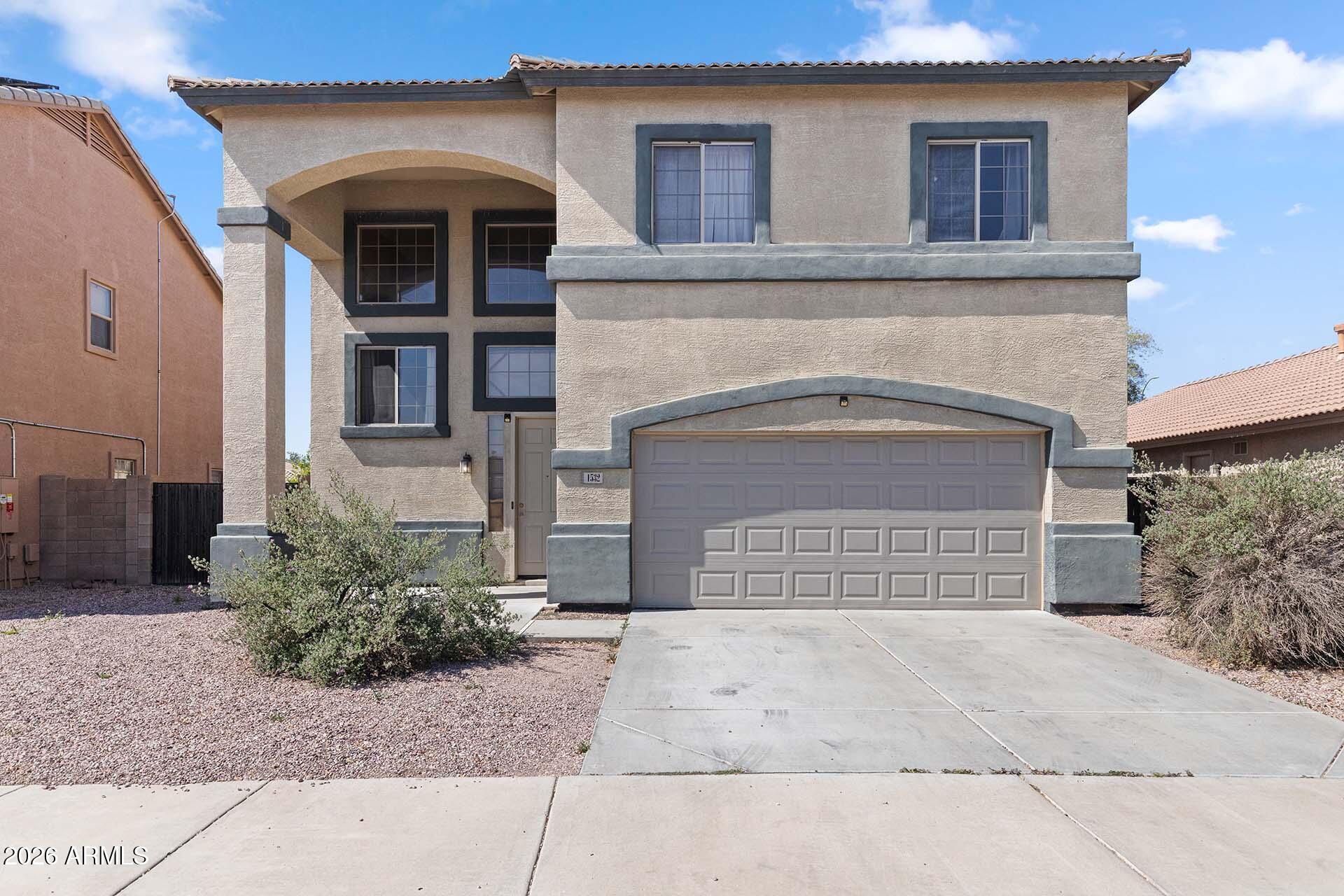 Location! Location! Updated two-story home in the heart of the growing West Valley! Spacious and updated 4 bed, 2.5 bath, 2 story home. All downstairs carpet has been replaced with tile, creating a clean, modern look and easy maintenance. The open floor plan features a cozy fireplace. Ideally situated just minutes from I-10 and Loop 303, with no neighbors directly behind for added privacy. Enjoy being within walking distance to a nearby park and benefiting from a low HOA in this fast-growing West Valley location in Goodyear. Upstairs, the primary suite includes a walk-in closet and an impressive oversized balcony--your own private retreat. The backyard offers a large patio and expansive grassy area, ideal for gatherings, play, or simply relaxing outdoors.