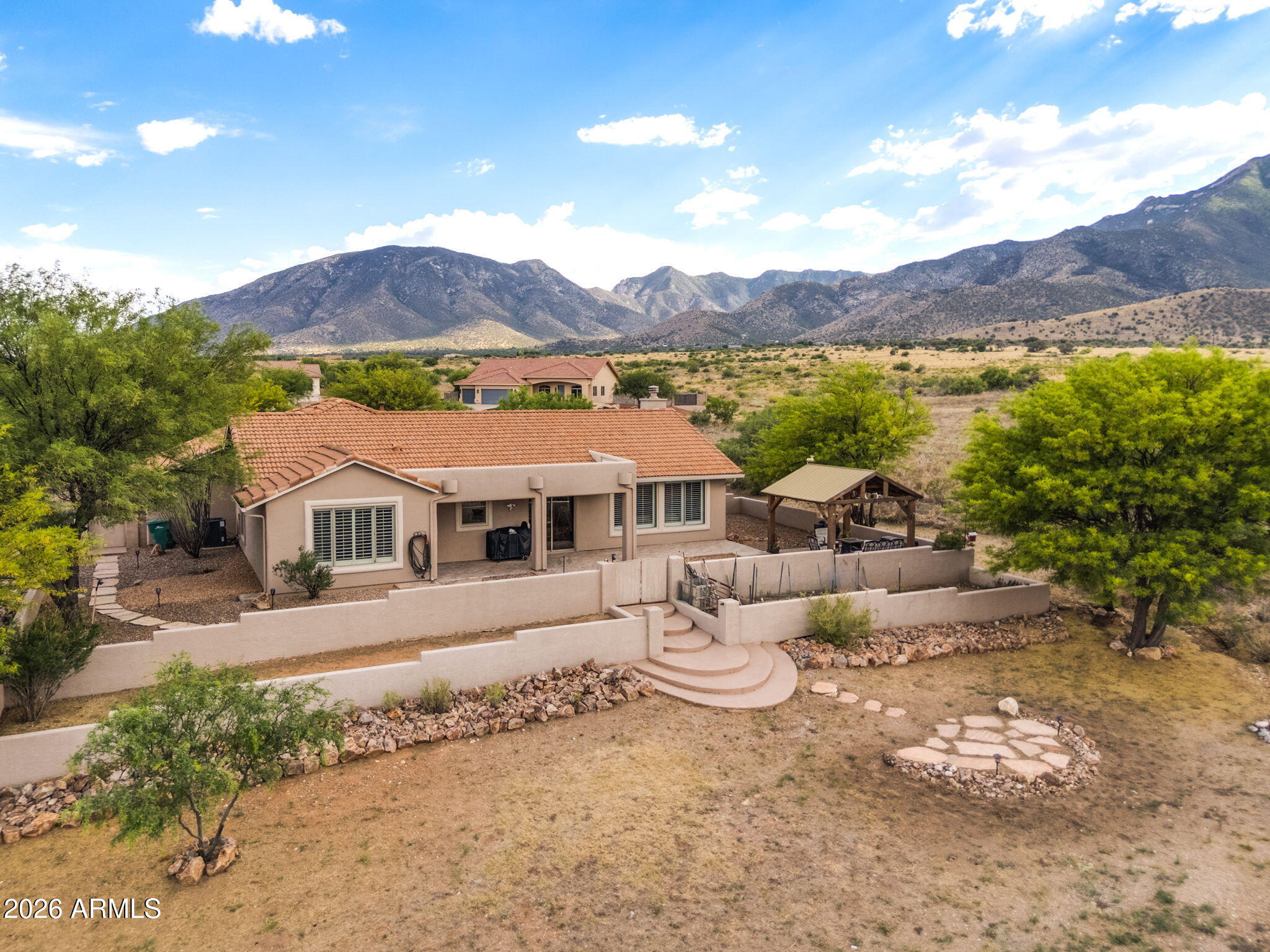 Located in a gated community in Hereford, AZ, this 4-bedroom, 2-bath home offers a desirable split floor plan, unobstructed mountain views, and direct access to community walking trails. Situated on a 1-acre cul-de-sac lot and backing to private HOA land, the property provides exceptional privacy and a peaceful setting.

The home features a 3-car garage and extended driveway, offering ample space for parking and storage. Inside, you'll find an upgraded kitchen and a stunning quartz stone fireplace that anchors the main living space with warmth and character. A well-designed layout and scenic surroundings make this home standout in a sought-after location.