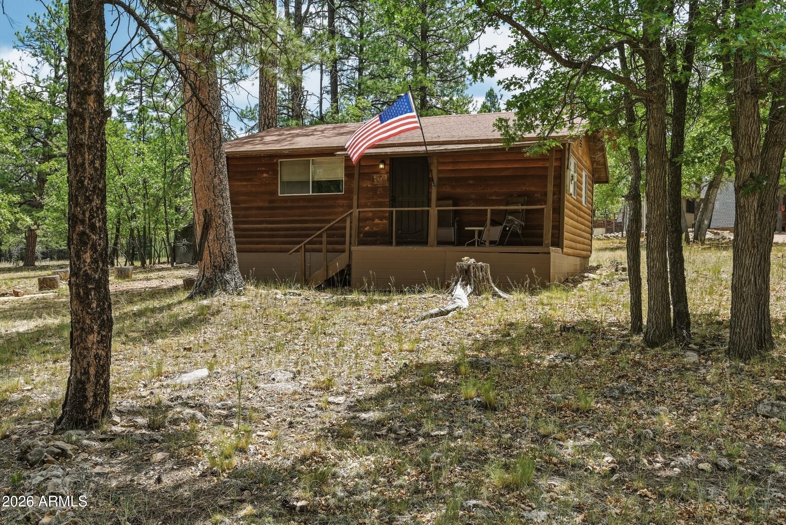 Old fashion cabin, its small but cozy. This cute 2 bdrm/1 bath home with a little front and back deck. Has nice T and G ceilings/wood walls and old fashion appliances in the kitchen.  Storage shed behind the home. This beautiful lot has potential to build a garage/workshop, bring your horses, or RVs. NON HOA lot. The lot adjacent to it is also available, PURCHASE BOTH TO HAVE OVER 2 ACRES. The options are endless.