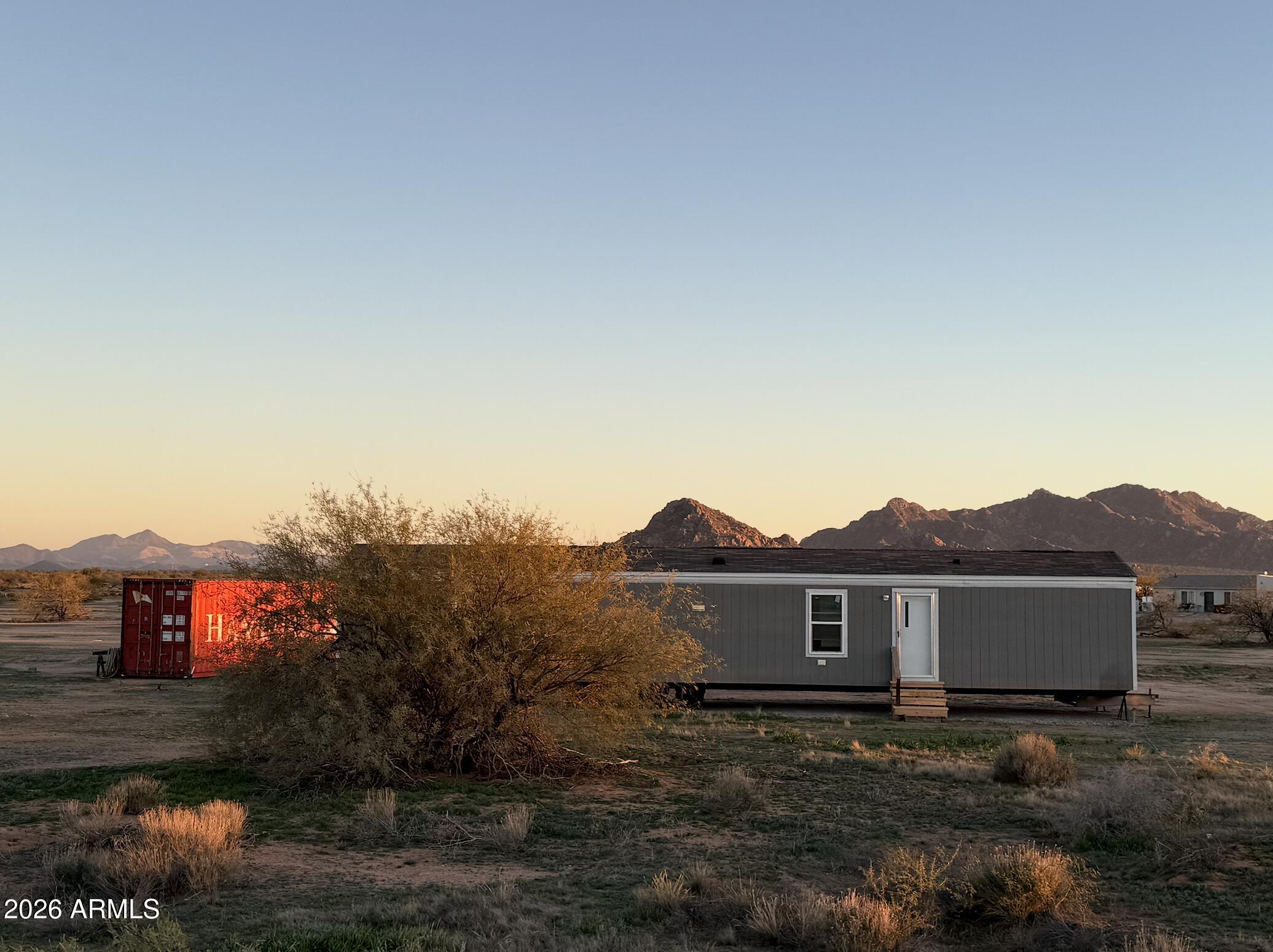 2 Bed 2 Bath Mobile home on 1.25 Acres in a serene desert setting. Paved roads, Water access, and Power access close by. With Connex Container for storage. This home is also solar-ready.
AC has not been purchased. Water & Electric are close by and need to be hooked up.