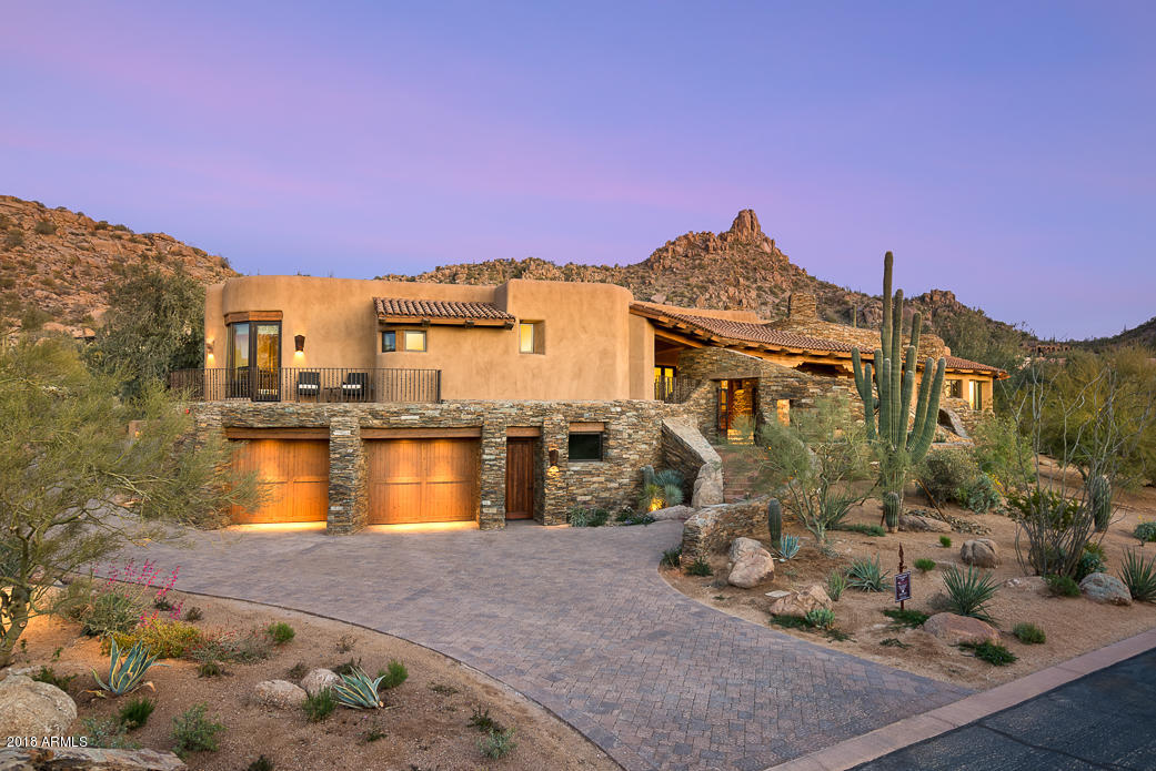 Recently completed custom home in the guard-gated community of Estancia * Located on the 8th fairway, the residence is a masterpiece of collaboration between Randy Romero (Builder), Lee Hutchison (Architect) & Bess Jones (Interior Designer) * This Organic Pueblo exudes warmth & elegance while taking in commanding views of Pinnacle Peak, golf course & city lights * One-of-a-kind master suite with separate his/hers baths & closets (complete with laundry) and private covered patio with fireplace & views to The Peak * Dual guest suites with access to private terraces provide city light views * As the centerpiece to the residence, the kitchen lacks no details and opens seamlessly to the family room, great room & formal dining * see more