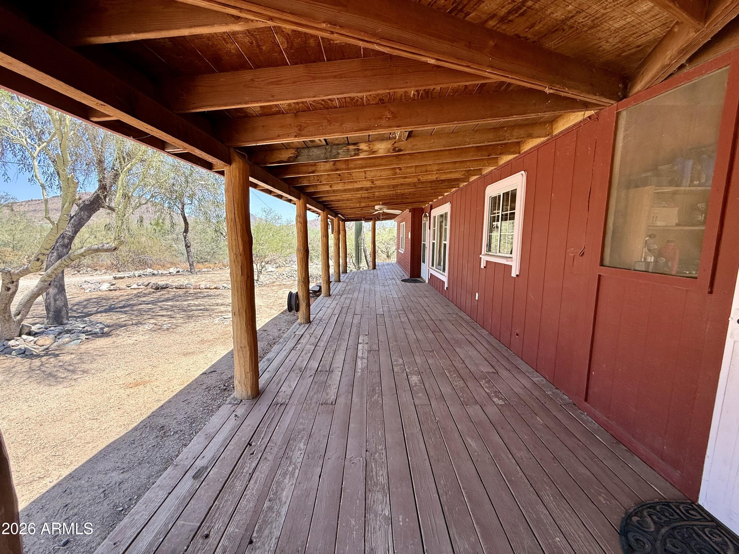This 3-bedroom, 1.75-bath residence offers distinctive character, thoughtful updates, and scenic surroundings. Recent improvements include a new roof, new AC system, and a well restored to working condition, providing added value and peace of mind. Architectural highlights include a welcoming wrap-around porch and rustic wood beam accents that enhance the home's warmth and charm. Positioned to capture stunning Daisy Mountain views and mountain vistas in every direction, the property offers a peaceful setting with exceptional natural beauty. A rare opportunity to enjoy character, modern improvements, and picturesque Arizona scenery.