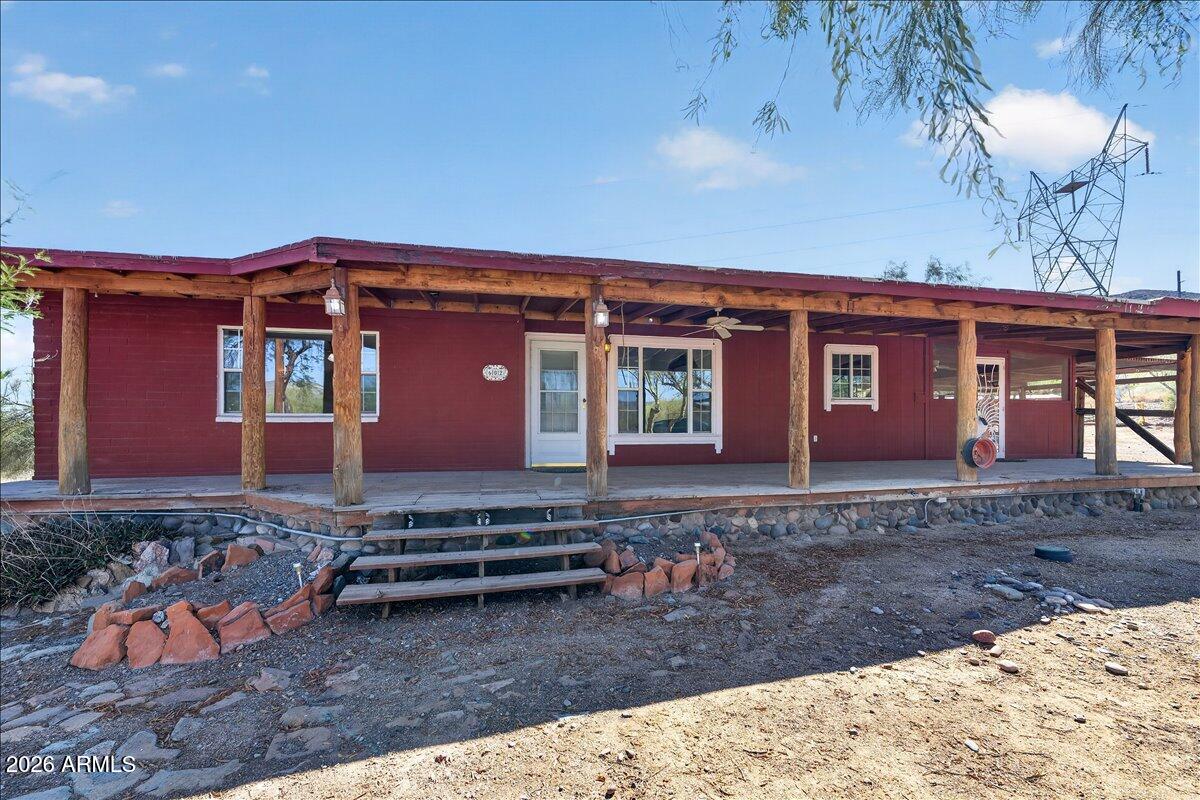 This 3-bedroom, 1.75-bath residence offers distinctive character, thoughtful updates, and scenic surroundings. Recent improvements include a new roof, new AC system, and a well restored to working condition, providing added value and peace of mind. Architectural highlights include a welcoming wrap-around porch and rustic wood beam accents that enhance the home's warmth and charm. Positioned to capture stunning Daisy Mountain views and mountain vistas in every direction, the property offers a peaceful setting with exceptional natural beauty. A rare opportunity to enjoy character, modern improvements, and picturesque Arizona scenery.