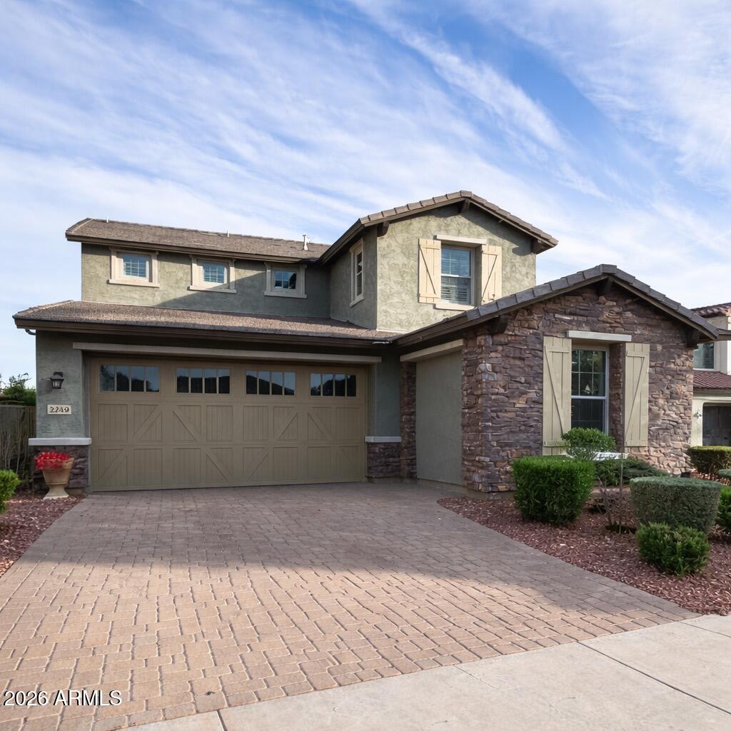 Located in the prestigious Verrado master-planned community, this stunning 5-bedroom plus den, 4.5-bathroom home shows like a model and offers exceptional space, functionality, and flexibility for a wide range of living needs. A standout feature of the property is the attached guest suite with its own private entrance, making it ideal for multigenerational living, long-term guests, a home office, fitness studio, or potential income-producing quarters. The suite can also function as a mother-in-law suite, private office, or optional sixth bedroom depending on your needs.

Inside the main residence, the open-concept layout is designed for both everyday comfort and effortless entertaining, centered around a spacious kitchen appointed with granite countertops, abundant cabinetry, and generous prep and storage space. The kitchen flows seamlessly into the main living and dining areas, creating a cohesive environment for gatherings, holidays, and family life. Thoughtful design, natural light, and well-proportioned rooms continue throughout the home, including three walk-in closets and upgraded plantation shutters that elevate both style and functionality.

Step outside to experience true Arizona indoor-outdoor living in a resort-style backyard built for relaxation and entertainment. Situated on a large lot, the outdoor space features a resort-style heated pool and heated spa, expansive hardscaping, and a large covered patio providing year-round shade and comfort. A spacious ramada adds an additional covered entertainment area, complete with a built-in wall, mounted TV, and integrated lighting, creating the perfect environment for hosting, lounging, or game-day gatherings. The built-in grill and bar area with mini fridge and natural gas hookup further enhances the outdoor kitchen experience. A fenced dog run offers a dedicated space for pets, and integrated outdoor speakers enhance the atmosphere for events and entertaining.

Additional exterior highlights include a three-panel sliding glass door that opens the home beautifully to the backyard, creating seamless indoor-outdoor flow ideal for entertaining.

Back inside, the home continues to impress with upscale conveniences such as an indoor bar area with mini fridge, KitchenAid appliances, and extensive built-in garage shelving for optimal storage and organization.

Beyond the property itself, residents benefit from all that Verrado has to offer, a highly sought-after community known for its small-town charm and upscale amenities. Enjoy access to scenic hiking and biking trails, numerous neighborhood parks, community pools, golf, fitness opportunities, and the vibrant Main Street district filled with shops, dining, and community events, all set against the breathtaking backdrop of the White Tank Mountains.

This exceptional property combines luxury, versatility, and lifestyle in one of the West Valley's most desirable communities, presenting a rare opportunity to own a move-in-ready home with private guest quarters and resort-style outdoor living.