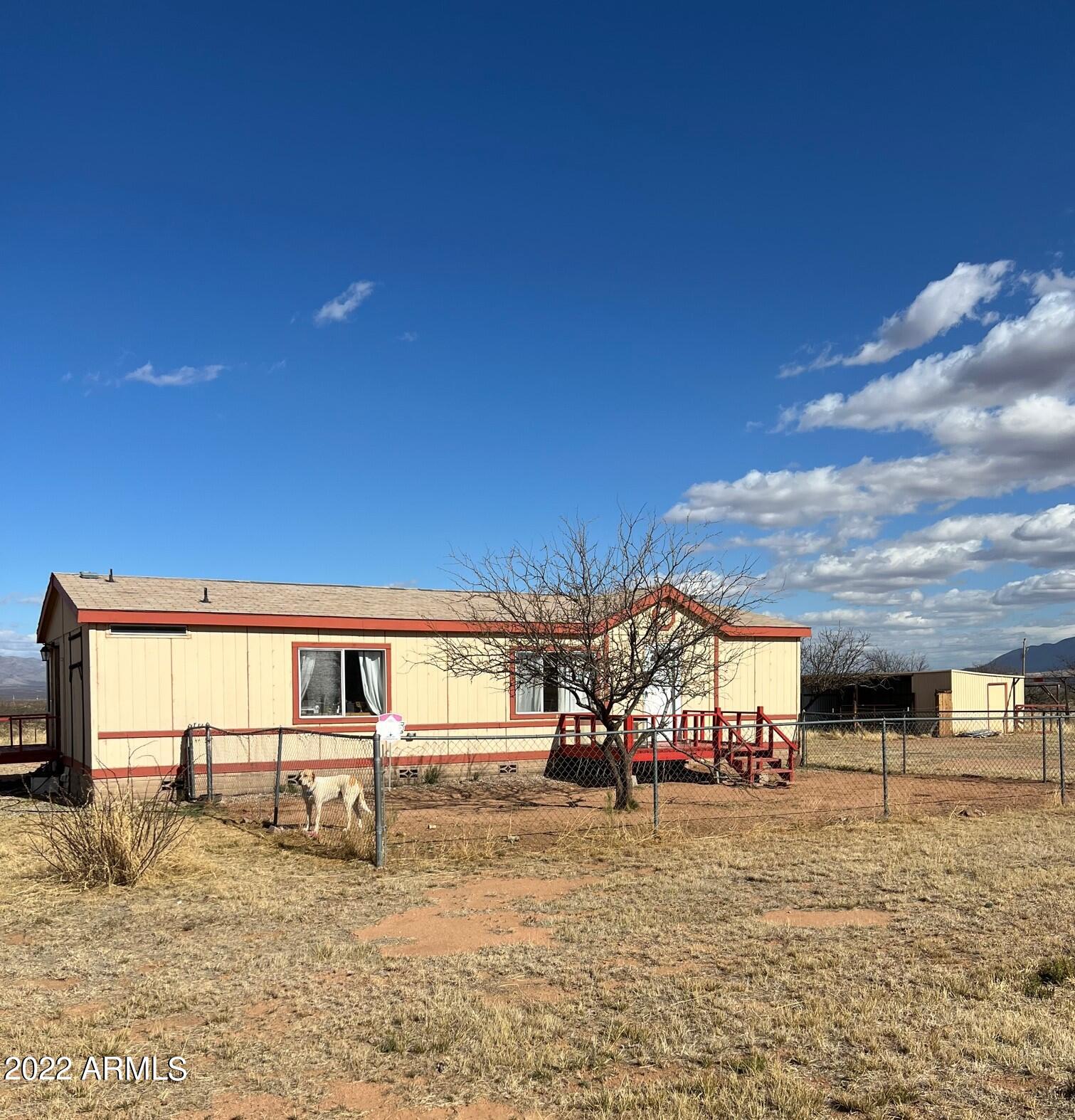 AMAZING 360 Degree VIEWS!!! Country living just minutes from Sierra Vista, Fort Huachuca or Bisbee. Located on a completely fenced 4 acre lot there is a corral and back pasture area for horses and other animals. Large kitchen with eat-in area and formal dining room. Spend your summer evenings sitting on the screened in porch enjoying the mountain views and cool breeze! This spacious 3 bedroom home has Central A/C, an Arizona room and a ''dinosaur room'' for those who are more adventurous! The outbuildings consist of a Large 2 room Workshop, a Duck or Chicken Coop plus another building that can be made into a private Man Cave, Casita, craft room or??? There are 2 hose bibs in the yard, separate fenced-in areas and an RV Hookup with easy RV entrance and parking. Call for a private tour today