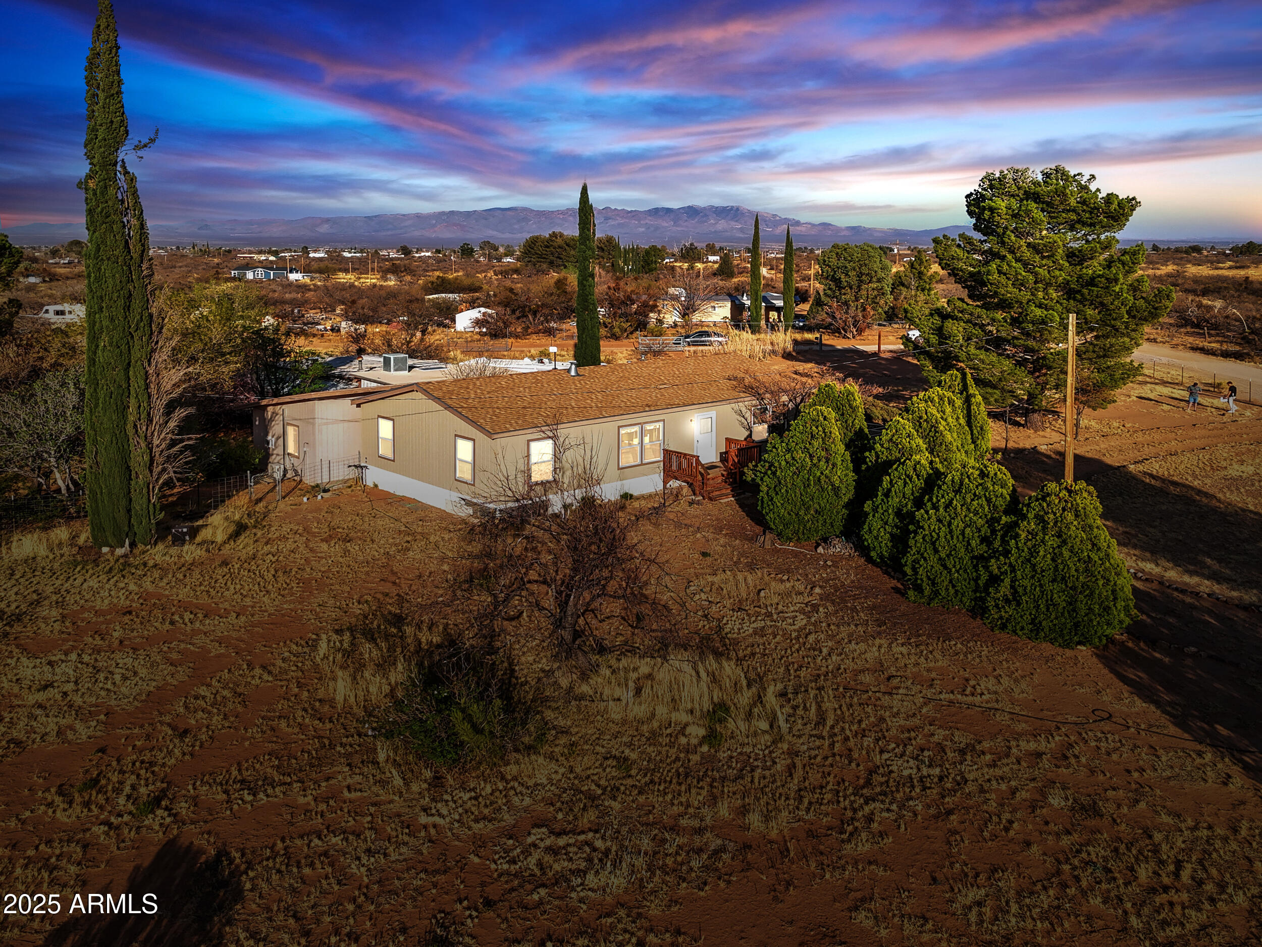 This charming 3-bedroom, 2-bathroom manufactured home is nestled on just over 4 acres of serene land, offering breathtaking mountain views.  This home offers a split floor plan with plenty of natural light.  With a stable, large workshop, and even a separate detached studio room--perfect for a home office, art room, or even a guest quarters, the options are endless!   It offers the tranquility of country living while still being close to local amenities. Whether you're looking for space to spread out or a property with potential, this one is a must-see!