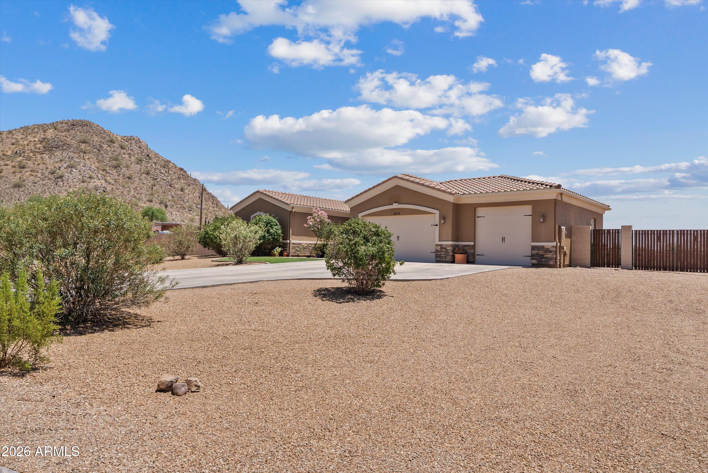 Enjoy breathtaking views of the Superstition Mountains and San Tan Mountains from this meticulously maintained custom home on 1.36 acres with no HOA! Connected to water & sewer, no septic. Inviting courtyard entry leads to a bright open floorplan with neutral color scheme and travertine floors throughout. Gourmet kitchen features granite counters, updated double ovens & oversized breakfast bar perfect for entertaining. Spacious backyard is designed for entertaining with a covered pergola, built-in BBQ island, gazebo,New oversized metal RV gate installed 2026, drip irrigation & endless mountain views under Arizona's cotton candy skies. Plenty of room for horses, toys, workshop or future expansion.