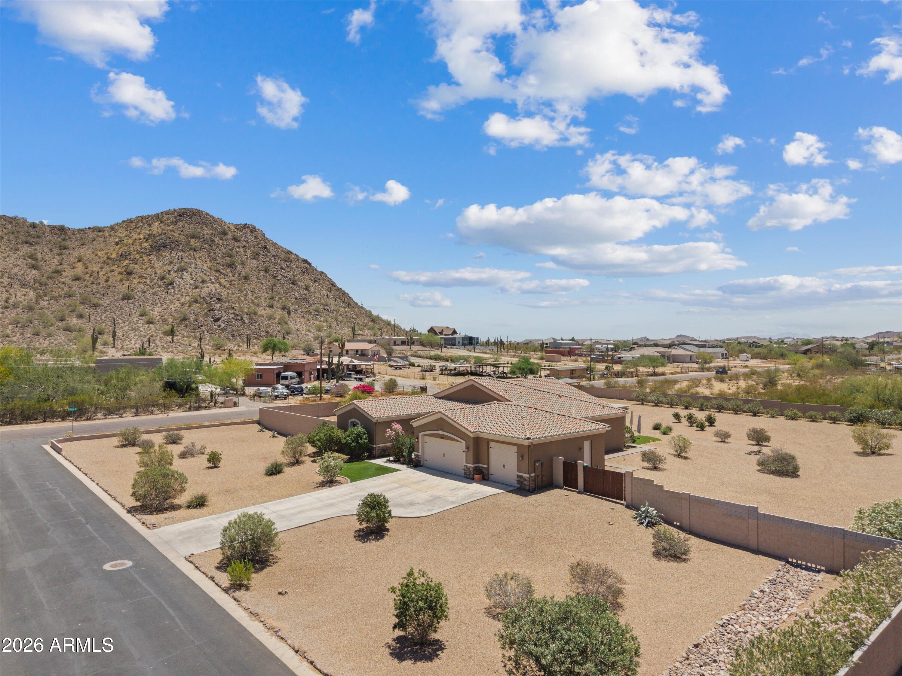 Enjoy breathtaking views of the Superstition Mountains and San Tan Mountains from this meticulously maintained custom home on 1.36 acres with no HOA! Connected to water & sewer, no septic. Inviting courtyard entry leads to a bright open floorplan with neutral color scheme and travertine floors throughout. Gourmet kitchen features granite counters, updated double ovens & oversized breakfast bar perfect for entertaining. Spacious backyard is designed for entertaining with a covered pergola, built-in BBQ island, gazebo,New oversized metal RV gate installed 2026, drip irrigation & endless mountain views under Arizona's cotton candy skies. Plenty of room for horses, toys, workshop or future expansion.