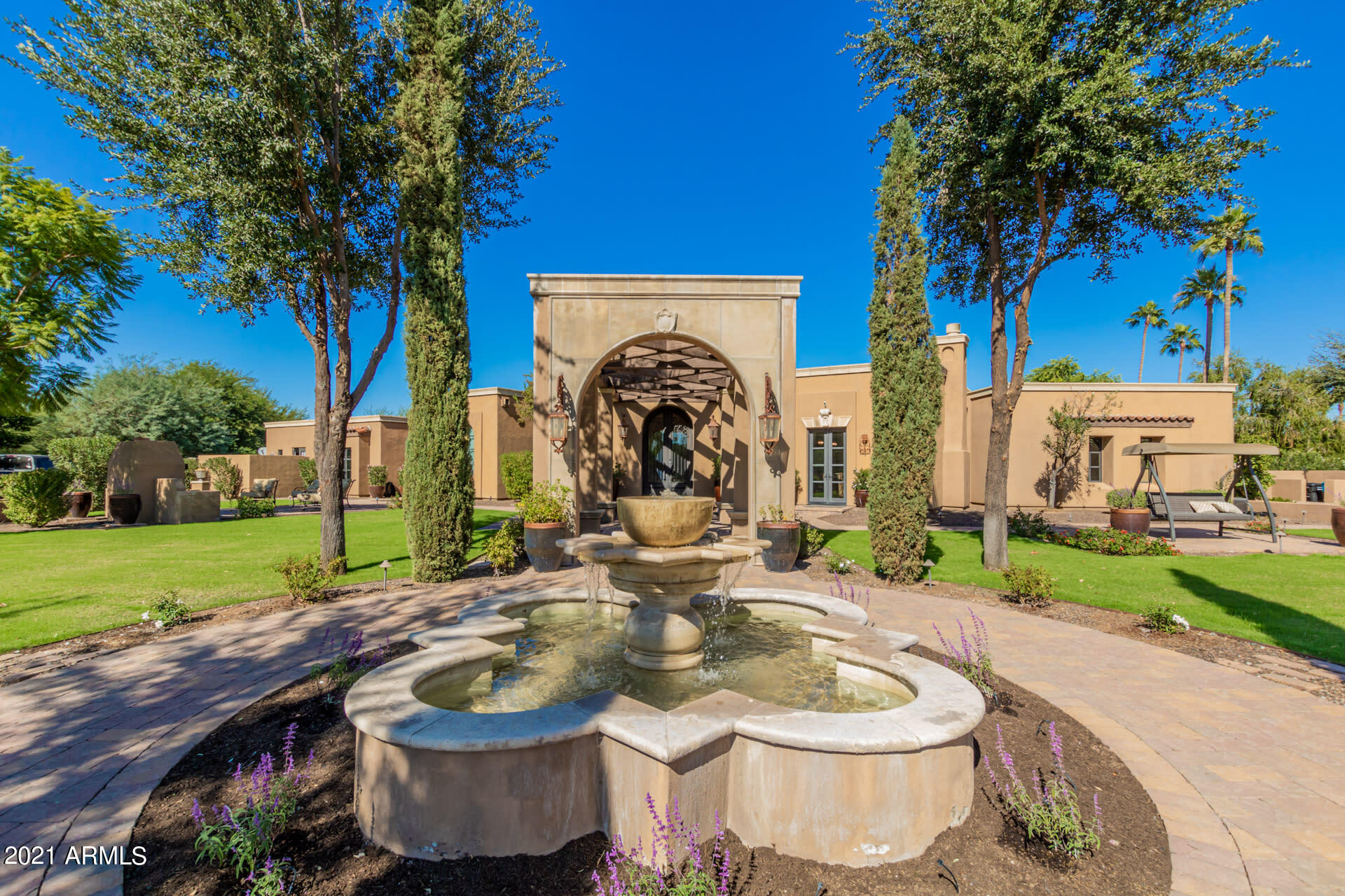 Privately gated and beautifully landscaped 1 1/2+ acre fully remodeled estate in Paradise Valley. Large front courtyard complete with water fountain, sitting areas and large gas fireplace. Interior features include a large gourmet kitchen with accompanying butler's pantry complete with custom cabinetry and windows overlooking the backyard. The Master wing includes his/her private bathrooms with shared shower and walk-in closets attached to each bathroom. The ladies bathroom includes a lovely cast iron claw foot bathtub and attached outdoor private patio with outside shower. Each of the other four large bedrooms has a private full bathroom with tile shower and granite sink countertops. There are three indoor gas fireplaces and saltillo tile & wood flooring throughout the entire house. Separate large recreation room includes an area for pool table, home theatre, and full bar with sliding custom windows that open to the backyard pool area. Gorgeous backyard includes large private pool with detached spa, custom sport court, putting green, new bocce court, large lighted wood trellis with fireplace, and custom in-ground trampoline. In addition to all that the home features Control 4 House Automation, Pentair Screen Logic Spa & Pool Automation, RV Pad, Full Outside BBQ Kitchen area, Warming Drawer, Two Mini Refrigerators in the Butlers Pantry & two dishwashers in the main kitchen!!