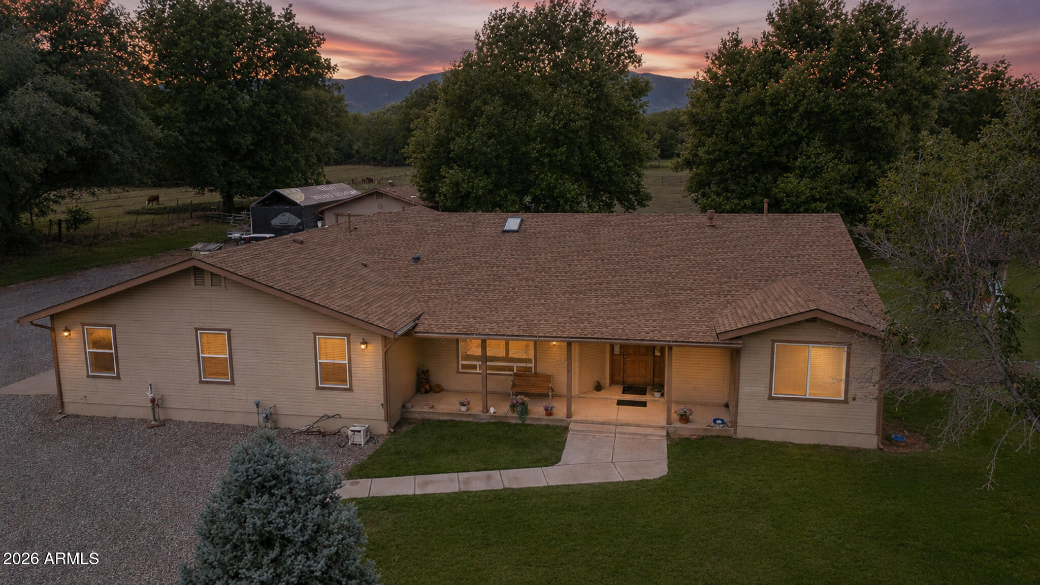 Set in Cottonwood's lush green belt, this property combines charm and practical living on a rare fully irrigated 1.07-acre lot. The home features 4 bedrooms, 4 bathrooms, and a split floor plan that maximizes space and privacy. Outdoors, enjoy fruit trees, garden beds, and a chicken coop for a touch of country living. A 900 sq ft detached garage offers ample room for vehicles or projects, and a 284 sq ft mother-in-law apartment with its own bathroom provides extra living space. Entertain with ease on open and covered patios with two gazebos, all set against the stunning Mingus Mountain backdrop. With RV parking, 30-amp service, and a 6kw owned solar system, this well-maintained property is ready for you. Ideal for those who value space, functionality, and a prime location.