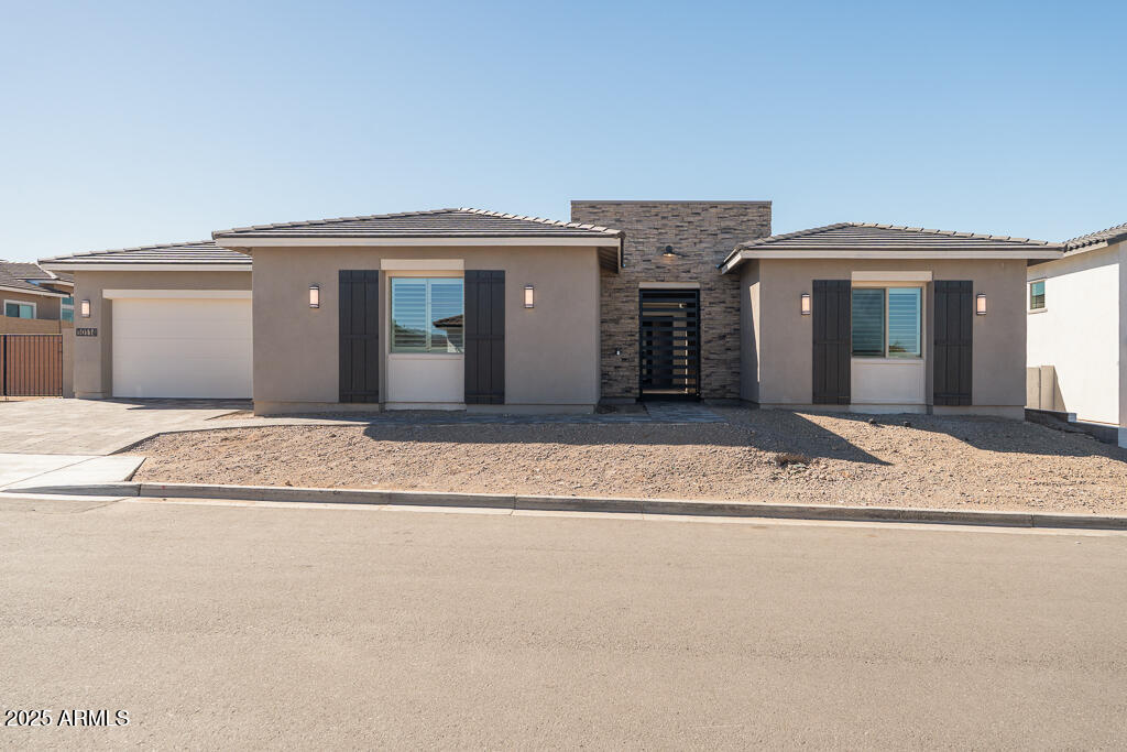 Remarkable, new, contemporary home loaded with designer upgrades. The home features 5 bedrooms, 4.5 bathrooms, a dining area and flex dining area, an office, outdoor living spaces, and more! The kitchen includes Cafe 36'' commercial style gas appliances with double ovens, a prep zone, a Blanco single bowl sink, Winstead Paint Greyhound cabinets with soft close doors and drawers, stacked upper cabinets, under cabinet lighting, and Della Terra Pro Frost Quartz countertops with tile backsplash. Other interior highlights include an extended primary suite with Della Terra Pro Frost Quartz countertops in the bathroom, brilliance stainless faucets at the bathrooms, a sink with lower and upper cabinets in the laundry room, and a corner sliding glass door at the Great Room.