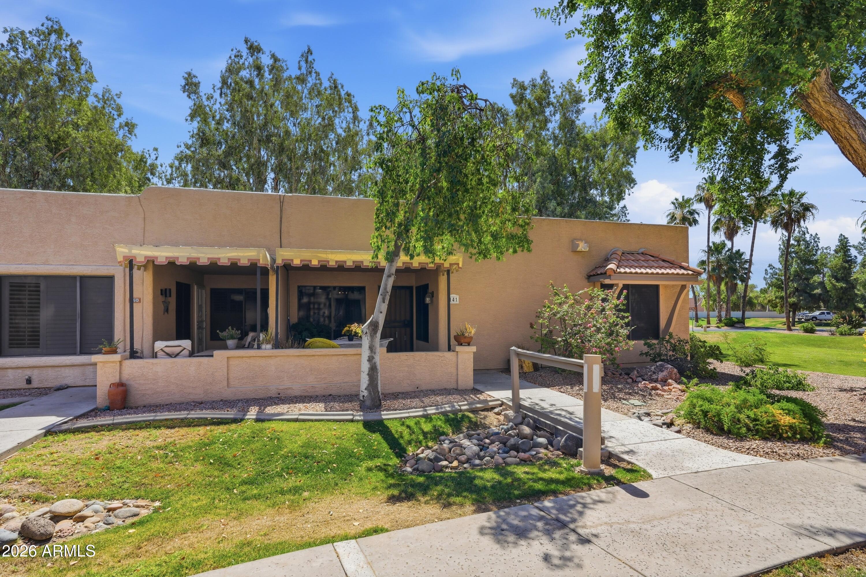 Located in the much desirable  adult community of Sun Village in the heart of Surprise, Arizona.  This attractive condo is an end unit with a lush greenbelt view and a walking bridge to your front door.  A new 2025 A/C insures a comfortable living environment year round.  Stainless kitchen appliances add to the aesthetics of a well appointed kitchen.  The community boast lush greenbelts, serene lake views, an 18-hole golf course, recreation center, pickleball courts, shuffleboard, horseshoes, crafts, cards, and a huge heated pool/spa and more!  Don't miss this opportunity.