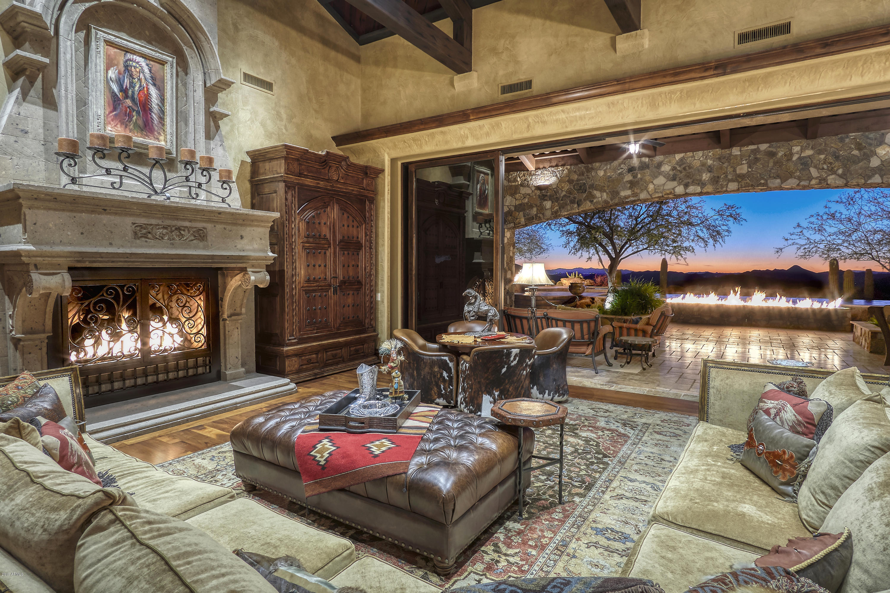Views from every window in this secluded Southwestern Old World estate on 12 acres w/ breathtaking panoramic views of Sonoran Desert & mountains. Great room floor plan has dramatic stone fireplace & automatic doors opening to outdoor living spaces. Finest finishes & amenities incl wood & stone floors, wood beamed ceilings, stone walls & ceilings, custom cabinetry & lighting, wine cellar & much more. 5 bedroom en suite, incl. guest quarters w/ family room, kitchen, laundry closet & 2 fireplaces; 6 full baths, 2 powder rooms, library/den, media room w/ wet bar, master suite w Cantera stone fireplace, workout room, laundry room, his & her baths w/ sep. showers, water closets & vanities. Backyard retreat w/ negative edge pool, spa, fire pit, BBQ, fireplace & multiple patios w forever views.