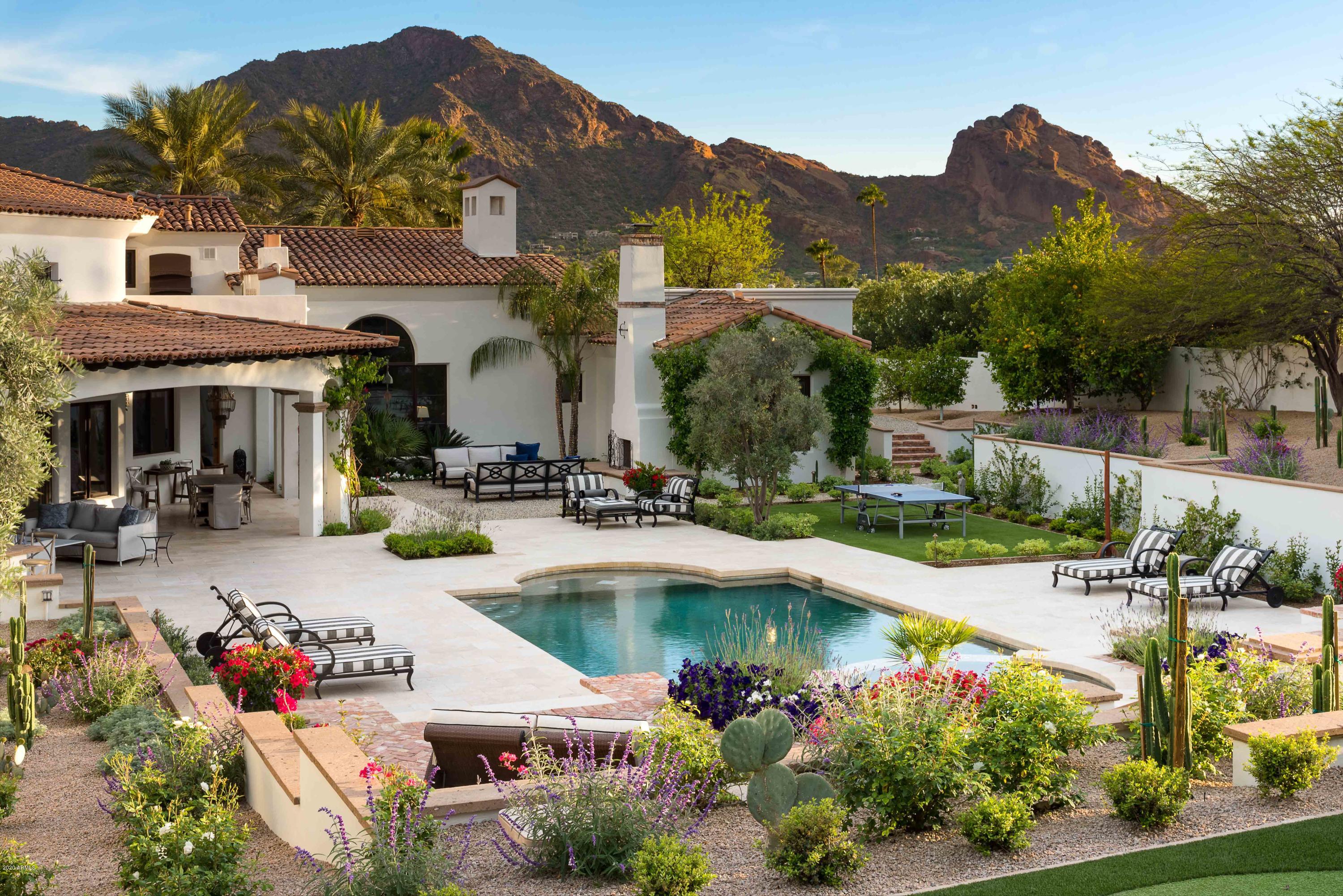 UNOBSTRUCTED CAMELBACK VIEWS TO THE SOUTH – GRAND ENTRY WITH SHOWSTOPPING MUMMY MOUNTAIN VIEWS TO THE SOUTH. Welcome to the Gold Coast of PV. The most coveted corridor in all of AZ! Centrally located from PV Country Club & Old Town Scottsdale. Indoor & Outdoor Living at its absolute finest. Fabulous 1.16 acres estate with professionally/fully redesigned low maintenance landscaping by Berghoff Design. Solid block construction, all living on 1 level featuring the 5 en suite beds, formal library, massive chef's kitchen w/ double islands, temp-controlled wine room & humidor, 5 car garages w/ EV charging. The Grand Master Suite features a fireplace, sitting area, private front courtyard w/ views of the Praying Monk on Camelback MTN, massive master bath w/ his & her closets...CLICK MORE ...vanities, WCs, & an attached exercise studio with pronounced Mummy Mountain views. Privately gated entry featuring a lovely circular drive & side vehicle entry. To top it all there is a strategically positioned en suite game room on a 2nd level - with 2 private balconies (one with a gas fireplace) & unobtainable elevated views. SMART HOME Control 4 manages it all; security, cameras, lights, music, TV, HVACs... see & regulate your home from anywhere in the world. Completely renovated landscaping, executed by renowned Berghoff Design Group, with ramada, fireplaces & professional golf practices areas. Elegance, livability, location! Call today for more information & to set up your Private Experience!