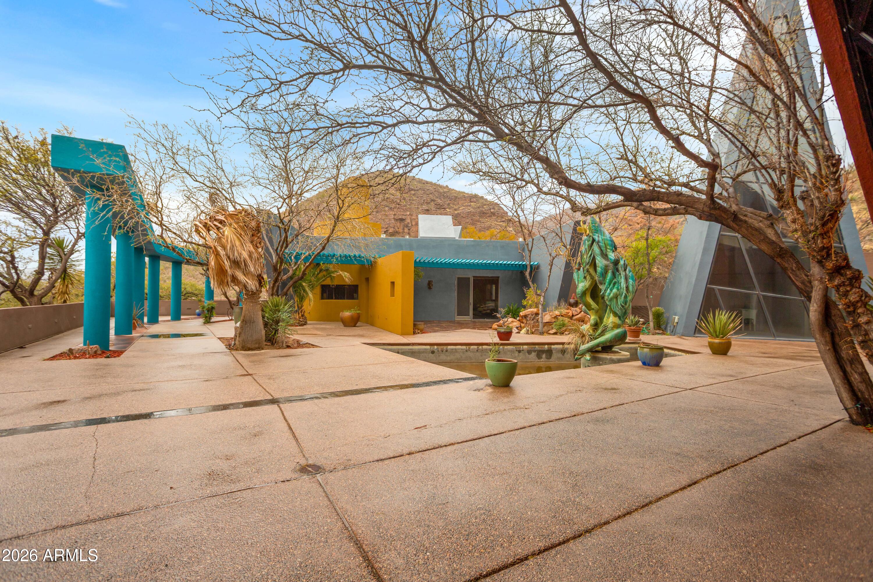 Discover a one-of-a-kind desert mountain compound tucked away outside historic Bisbee, offering a spacious main residence, guest apartments, a yoga loft, and a dedicated artist studio perfect for artists, retreats, or income potential as a ranch and or as a guest ranch.  Surrounded by peaceful high-desert views with a total of 2,600 acres comprising 770 acres of deeded land with the balance in state and BLM leases. This is a working cattle ranch that currently holds 57 head of black angus beef.   Located approximately 20 minutes outside of Historic Bisbee Arizona and a short 1.5-hour drive to Tucson International Airport.  Accessed by a scenic dirt road, this unique rural property offers privacy, wide-open desert views, and peaceful surroundings. The main residence of 4,364 square feet features 3 bedrooms, 3 bathrooms, two spacious living rooms, a gourmet kitchen, and a dedicated laundry room, providing comfortable and functional living space.  The owner's compound has an infinity pool and spa overlooking the magnificent Sonoran Desert Valleys.  Wander about the large patio areas filled with lush landscaping and three ponds with artistic waterfall features.  This home is off the grid with a large generator and private well.  Situated in one of the famous sky islands of Arizona it offers a unique wildlife wonderland with Mule and whitetail deer, javelina, black bear, mountain lions, coyotes, coatimundis, ring tailed cats, and three species of quail, to name a few.  This area is known as the northernmost range of majestic jaguar, ocelot and Mexican Grey Wolf.

The property also includes several detached exterior structures creating a versatile compound. Outside you will find a two-story yoga room/loft apartment, two separate guest apartments, and an outdoor bathroom with an additional laundry area. A separate detached building currently used as an artist studio offers the perfect space for artists, workshops, or creative projects.

This one-of-a-kind property offers incredible flexibility as a private retreat, artist compound, multi-generational living space, or income-producing investment, all set in the beautiful high desert landscape near the vibrant and historic community of Bisbee.