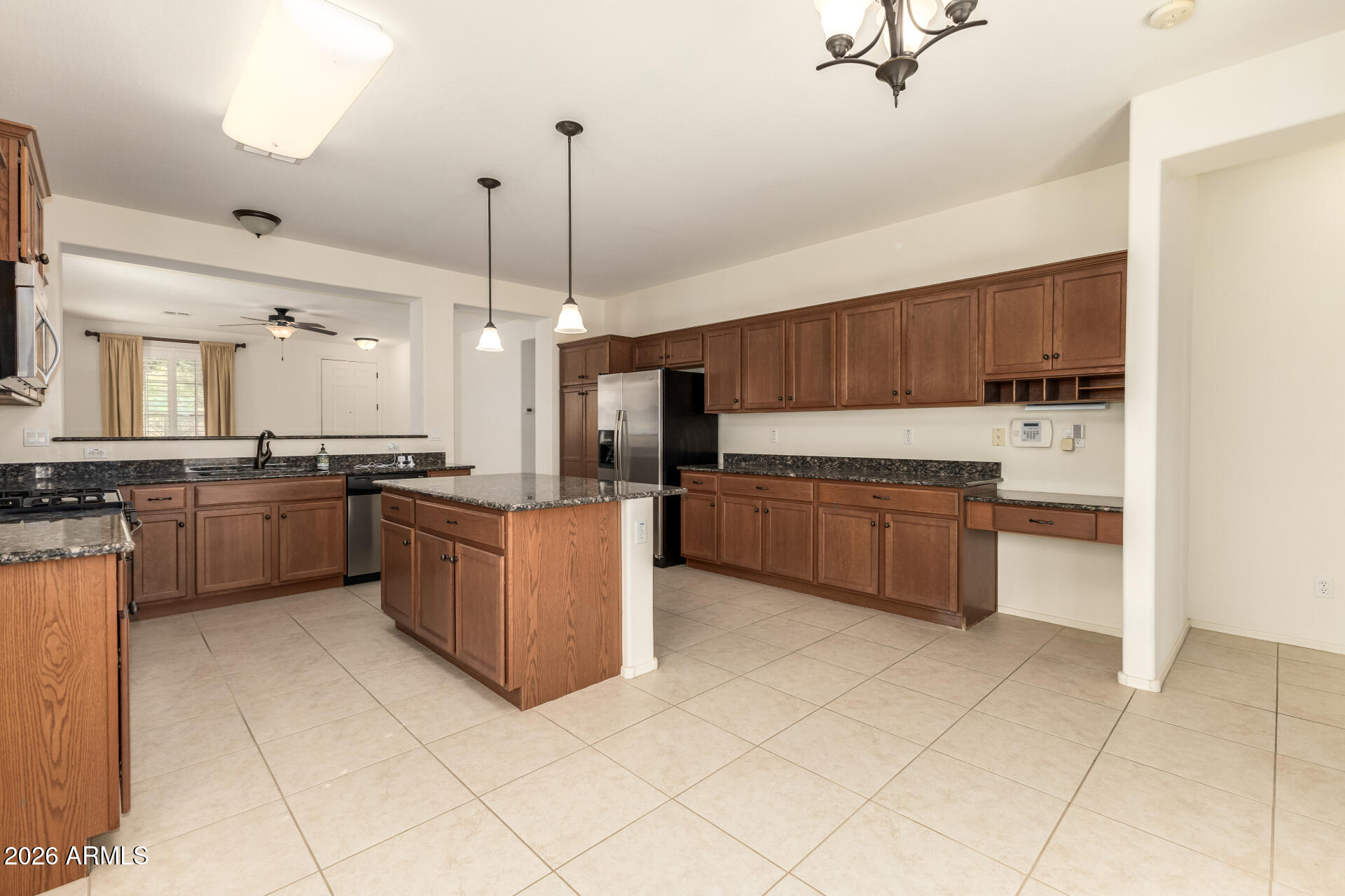 Beautiful Move-In Ready Solar Home! Enjoy a FREE solar system for your comfort and enjoyment.  Inside, you'll be greeted in sizable living areas filled with natural light, showcasing tile floors, plantation shutters, and neutral paint that works great with any decor style. The impeccable kitchen is a chef's delight, offering plentiful storage cabinetry, Granite countertops, lots of counter space, and an island, perfect for meal prep and entertaining. The main retreat features a private exit, a bathroom, and a walk-in closet for effortless organization. Get ready for weekend grills and peaceful evenings in the backyard, complete with a cozy covered patio and ample seating space with an easy-care desert landscape. Hurry up, this gem won't last!