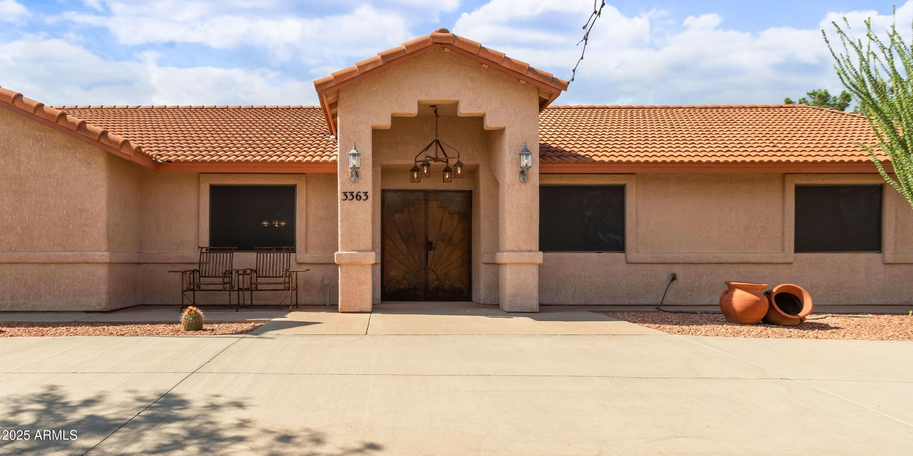 Experience luxury and convenience on 1.87 acres in Ranchos Carmela. This 3-bedroom, 3-bath home is designed for both comfort and connection. Sunlight fills generous living areas, while a split bedroom layout offers privacy when you need it. The expansive primary suite is a calm retreat. The patio invites you to pause, relax, and enjoy the surroundings. An oversized 3-car garage and 1,024 sq ft workshop with its own office and an additional bathroom gives you the space to take on projects or a creative studio. Epoxy floors keep both garages polished and easy to maintain, with two RV hookups and extensive parking adding ease. Some recent updates include tile with baseboard trim (May 2025) and carpet (Feb 2024). This is a property where you can truly live fully in the present.