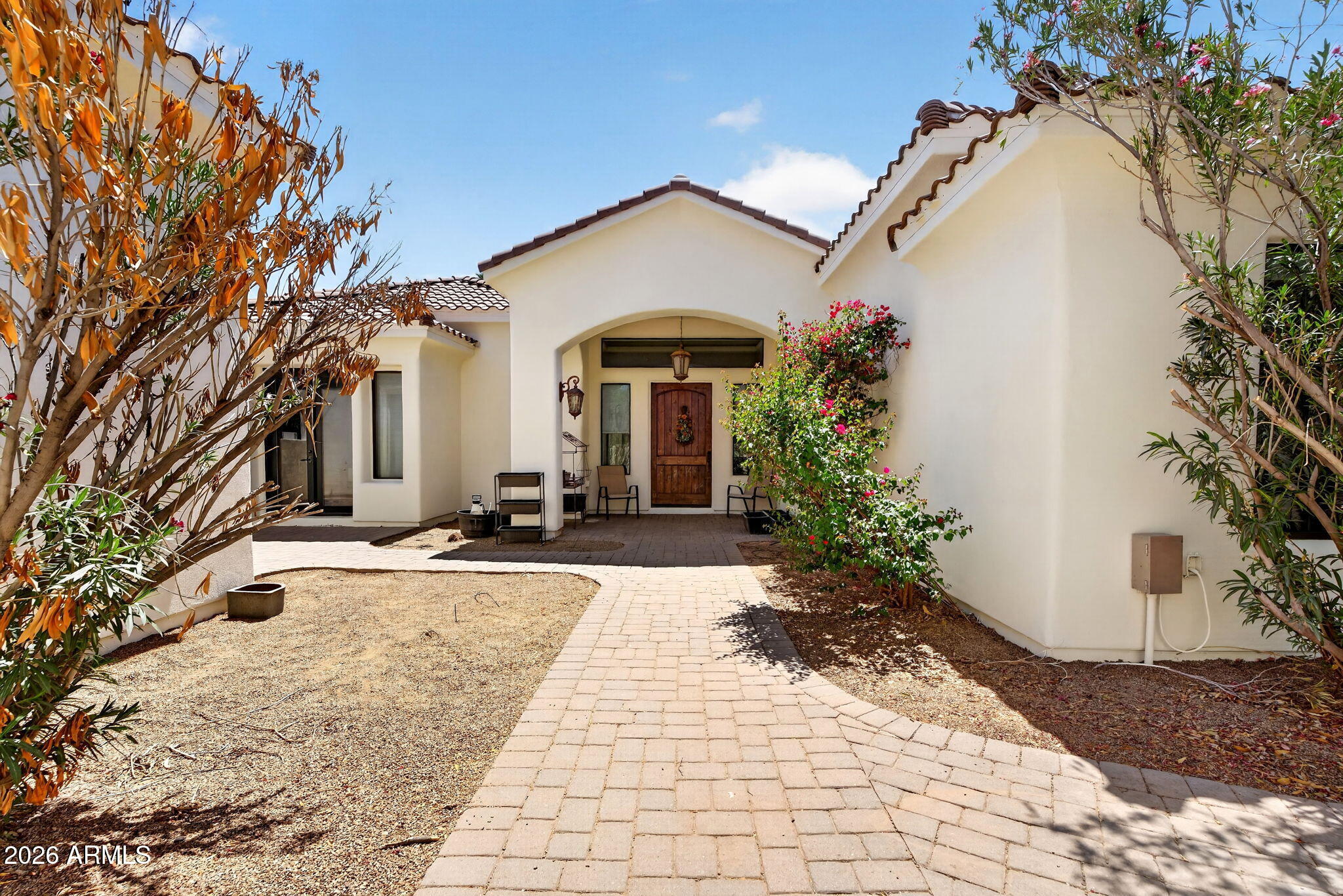 Set on a generous lot in Queen Creek, this property offers space, flexibility, and a timeless layout. From the expansive front yard and paver driveway to the private courtyard, it makes a strong first impression. Inside, you'll find 5 bedrooms and 5.5 bathrooms with 9+ ft ceilings, a spacious family room, and an open layout. The kitchen features a center island and granite countertops. The primary suite offers dual sinks, separate tub and shower, and two closets, while all secondary bedrooms include private baths and walk-in closets. The backyard features a private pool, covered patio, and swim-up bar--the pool was just acid washed and refilled. Includes horse corrals, RV garage, and guest casita. Great bones and floor plan with tons of potential. Freshly painted exterior!
