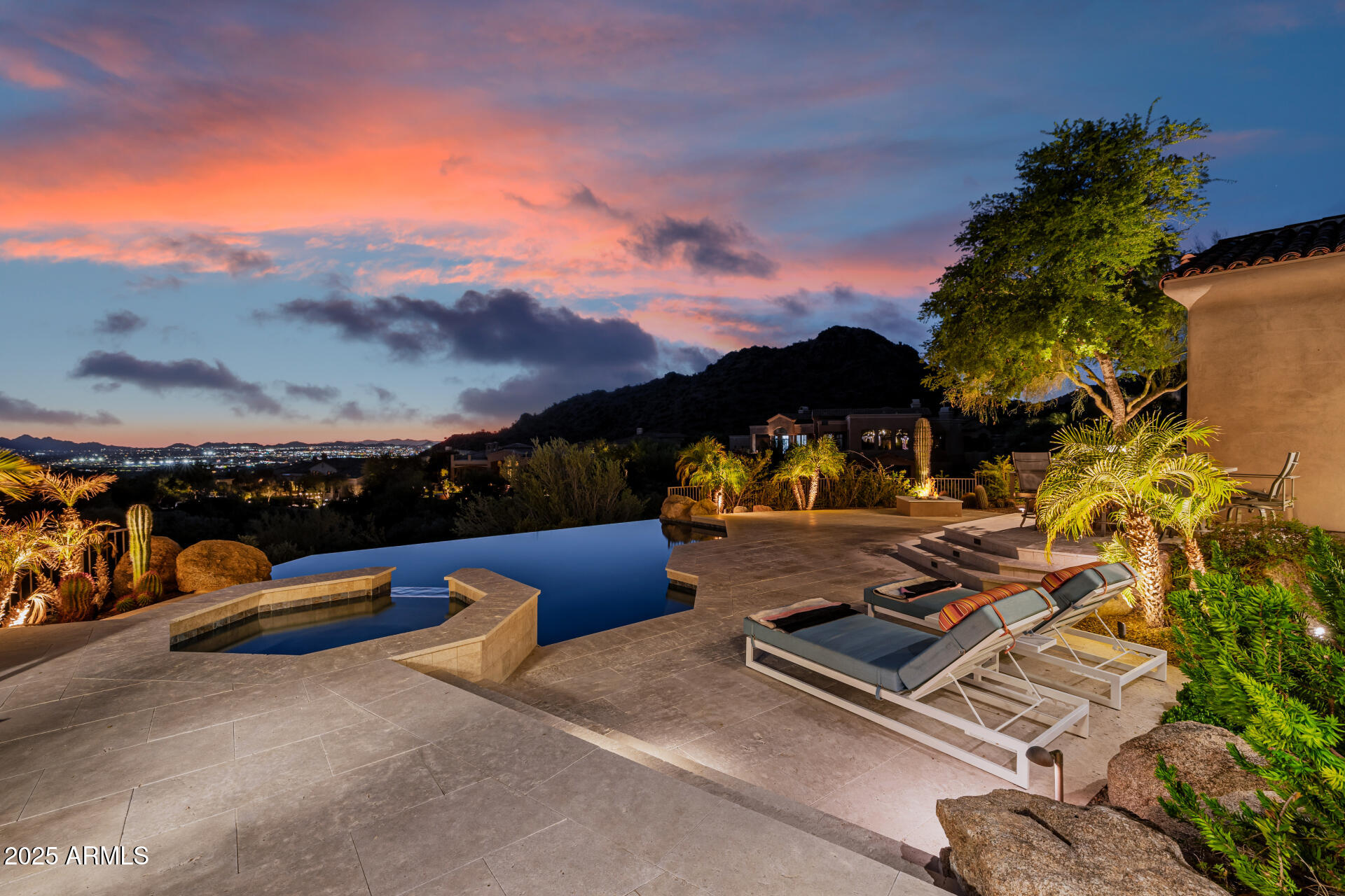 Back on the market with a completely renovated backyard oasis. Over 110K in upgrades. New pool finish, waterline tile, infinity edge, new pool equipment, limestone pavers. Views! Views! Views! No interior steps! All on one level.  This premium ultra-private homesite has breathtaking mountain and city light views, including the iconic Camelback Mountain. The 75-yard driveway leads you to your luxury estate tucked away in the McDowell Mountains. Nestled on a premium cul-de-sac lot, this 3 bed, 3.5 bath home has a 3 car garage w/built-in cabinets, desert landscaping and great curb appeal. The main living area features an open floor plan with massive sliding doors and windows, allowing light to shine throughout. This modernized open-concept floor plan features a great room design with multipl living and dining areas. The luxurious kitchen is worthy of a chef, offering ample cabinetry w/crown moulding, granite counters, a large pantry, mosaic tile backsplash, a center island, and a breakfast nook. The lavish primary suite has a soaking tub with breathtaking views, a marble tiled shower, and an enormous closet with center island. Enjoy the seamless transition to the outdoor living spaces with multiple patios, negative edge pool and spa, BBQ, and firepit. Elegant wood flooring, an office/den , 2 fireplaces, and soaring 13 foot ceilings make this home a true gem. Don't miss this rare opportunity to live in a private and ultra quiet sanctuary close to all Scottsdale has to offer.