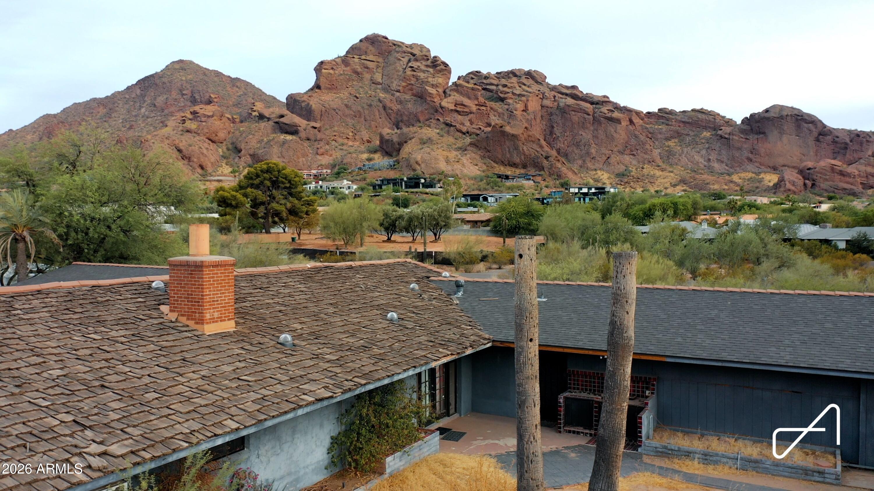 Attention Builders & Investors: Exceptional 1.6+ acre Paradise Valley opportunity just two blocks from Camelback Mountain, featuring unobstructed, breathtaking views and city sewer already connected. Surrounded by ultra-luxury estates, including multiple new construction homes exceeding $10M and a neighboring teardown that recently sold for $3.97M. Enjoy panoramic views of Camelback Mountain, Mummy Mountain, and the Phoenix Mountain Preserve. The current residence is being sold as-is, with no HOA restrictions. Consider a rooftop deck to maximize the extraordinary sunset and city-light views. This is a rare chance to create a world-class estate in one of Arizona's most prestigious locations!! Also listed as Land/Lot.