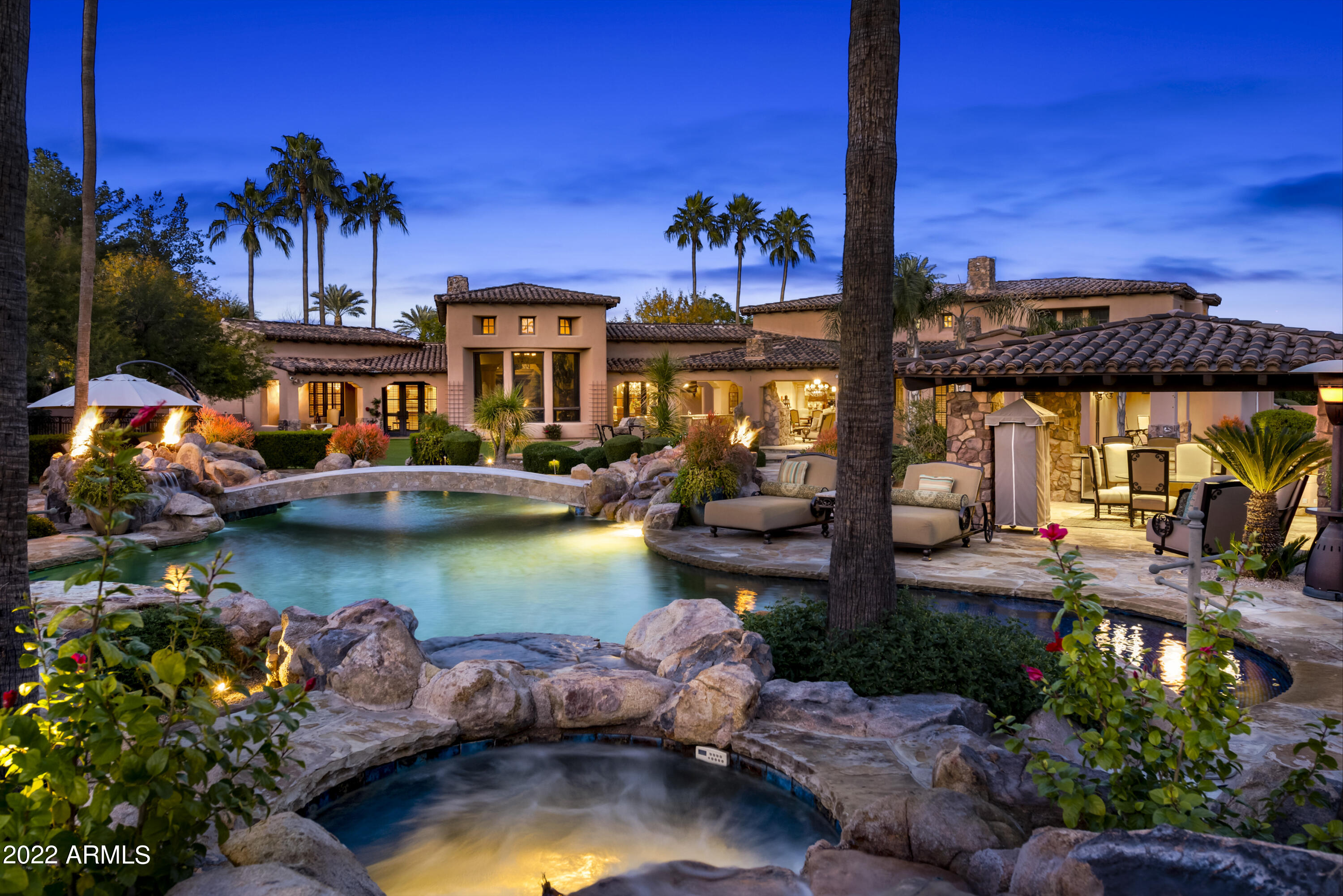 Exclusive guard-gated community in the heart of Paradise Valley in prestigious Judson neighborhood. This impressive custom home is an entertainer's delight w fabulous indoor/outdoor living. Incredible chef's kitchen w double islands, gas range, granite countertops & a gorgeous butlers pantry that extends to formal dining. Kitchen opens to the warm family room & welcomes in the incredible resort-style backyard w retractable french glass doors. Enjoy the remarkable outdoors w a choice of covered patios flanked w fireplaces, al fresco dining, ramada w outdoor kitchen & the sparkling heated pool designed w boulders, outdoor firepits & putting green. Beautiful ensuite bedrooms. State of the art Crestron technology/security system. Theater & billiards/game room tucked away from main floor living