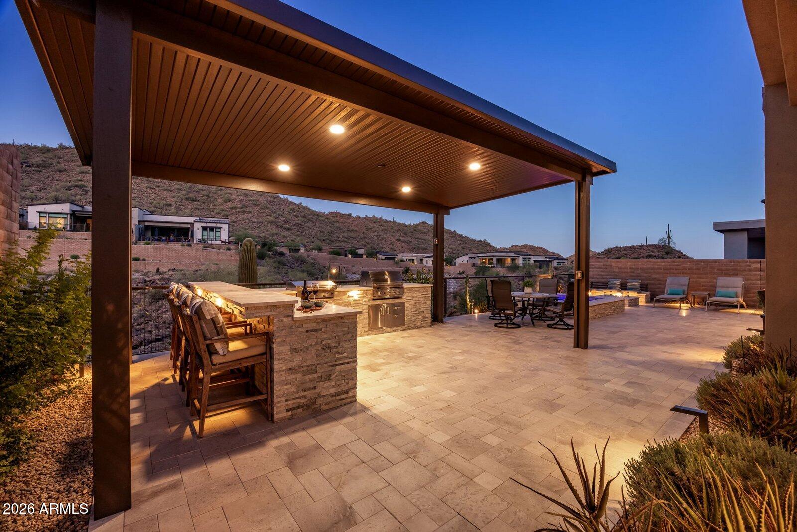 Experience refined desert luxury in this spectacular, extensively upgraded Toll Brothers residence in coveted Adero Canyon, where breathtaking canyon views, resort-inspired outdoor living, and timeless craftsmanship define every space. Showcasing over $739,000 in premium builder upgrades and custom after-market enhancements, this thoughtfully designed split floorplan offers two private ensuite bedrooms plus a private executive office, providing the ideal balance of comfort, privacy, and flexibility. Chef's kitchen features Wolf appliances, 48'' Sub-Zero refrigerator, Taj Mahal quartzite waterfall island and countertops, ceiling-height full-overlay maple cabinetry, and a True dual-zone wine refrigerator. Elegant wide-plank hardwood flooring, a dramatic linear fireplace, 14.5 ft ceilings, solid-core doors, white interior framed Anderson windows, automated Lutron shades and lighting, ELAN whole-home automation, designer lighting, and integrated audio. The climate-controlled epoxy garage includes EV charging prewire. Outdoors, relax on the expansive covered patio with heated spa, custom lighting and water feature, pergola, built-in BBQ and cooktop, fire feature, outdoor entertainment, and wrought-iron view fencing designed to maximize spectacular canyon vistas. Every detail was thoughtfully selected to create a retreat that seamlessly blends timeless design, modern technology, and effortless Arizona indoor-outdoor living.

Enjoy direct access to Adero Canyon trailheads, proximity to world-class golf and Fountain Hills dining, and the option to join the Adero Resort & Spa for fitness, tennis, pickleball, and resort amenities.

Comprehensive list of luxury features listed in Documents Tab in MLS.