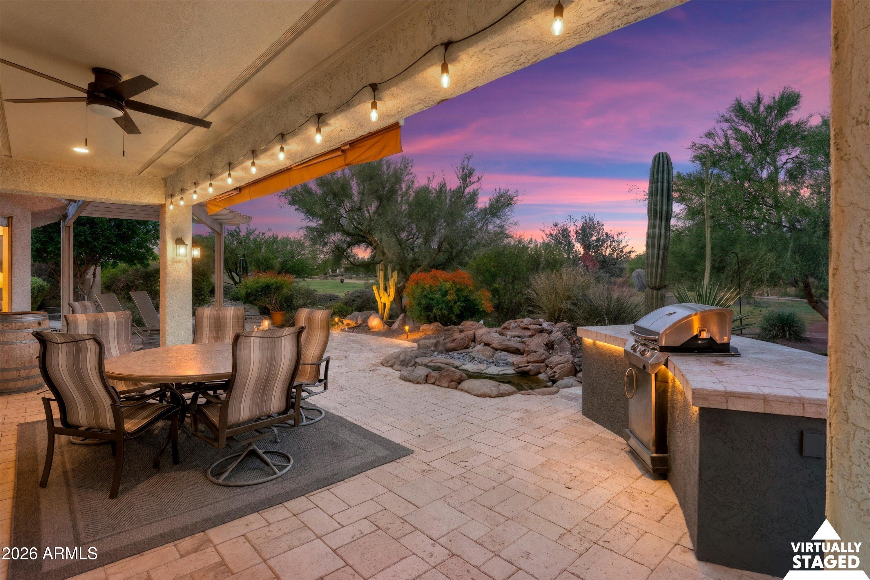 This is NOT your typical Gala model!  It features expanded interior living space and has been remodeled with contemporary upgrades and design features.  Located on the beautiful 7th hole of the Lakes Golf Course in Sun City Festival with expansive water views, this 3-bed, 2-bath home also includes a full size 3-car garage and an owned solar system for low electric bills.  The interior remodel has created a kitchen with a single-level white quartz island with a single-basin stainless steel sink, white tile backsplash, and upgraded gray cabinets with rollout trays and soft close drawers.  The appliances are stainless steel with a gas range. There are laminate wood floors in the main living areas with carpeted bedrooms and with surround sound in the great room and on the patio. The Owner's suite includes built-in drawers in the closet, and both bathrooms have been upgraded with quartz counters and tiled showers with frameless glass doors.  The third bedroom has been expanded to provide sleeping and living space with a large walk-in closet.  The back yard features an expanded travertine patio with Pergola, built-in grill and water feature and an expandable canopy for extra shade.  The front of the home has an east-facing walled travertine courtyard for enjoying the morning sun.  The laundry has upper cabinets for storage, and the garage features an epoxy-coated floor, soft water system, tankless gas hot water heater, and built-in sink with cabinets. There is also an attached storage room at the south side of the home.