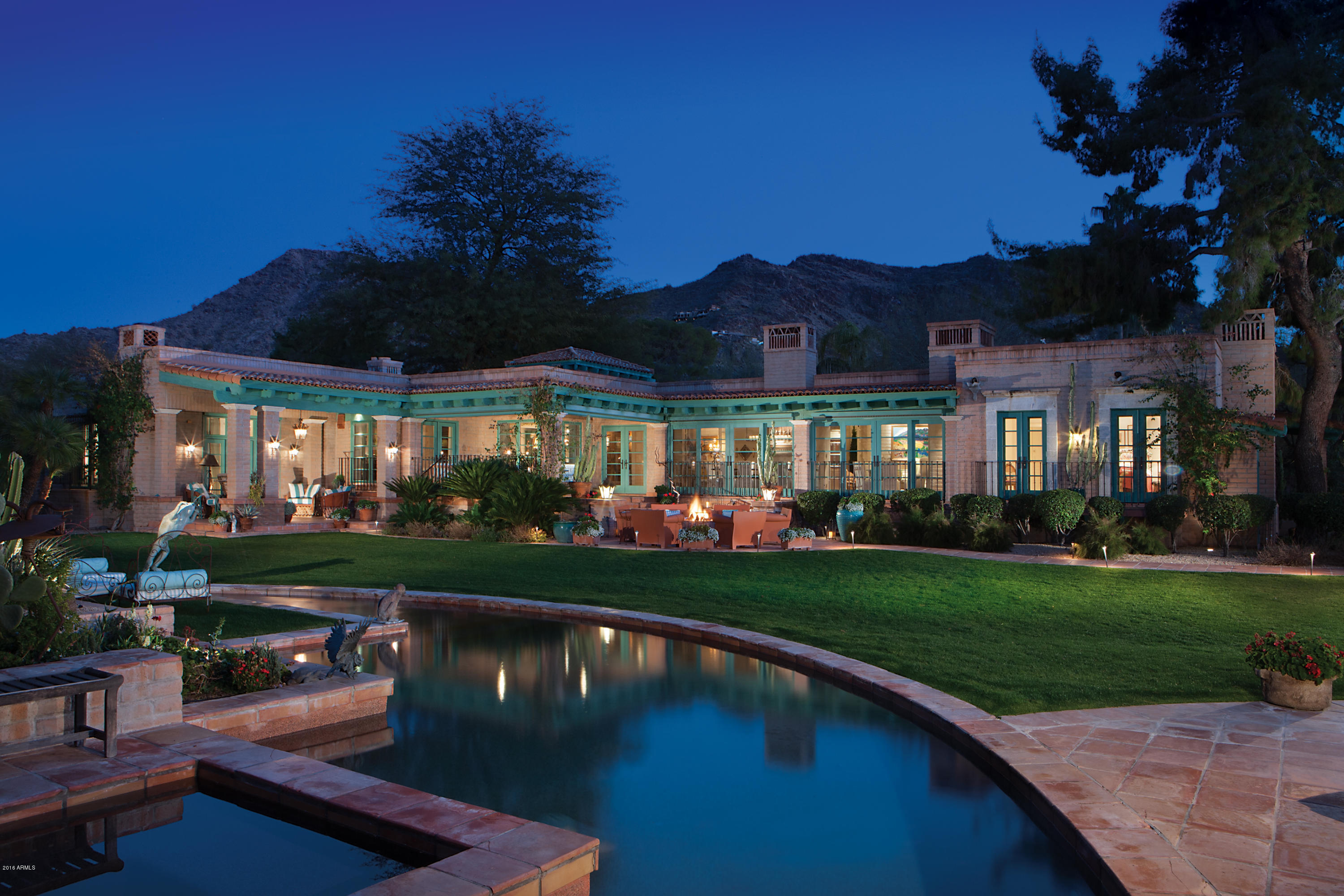 Timeless charm and classic Arizona design in this outstanding Paradise Valley estate compound. Enter through the beautiful private courtyard with its artistic carved doors to the home featuring Queen Creek Adobe block construction,a terra cotta tiled roof and custom ironwork. Inside the split floor plan offers 4 spacious en suite bedrooms, 2 offices, 6 fireplaces and an impressive chef's kitchen. The home is surrounded by inviting patios, gardens, an expansive lawn with pool, spa and fire pit all surrounded by mountain views. Outside there are two additional buildings which can serve as guest houses, artist studios, pool cabanas or fitness centers. This home entertains hundreds of guests with ease. Truly one of the most enchanting and authentic Arizona homes in Paradise Valley!
