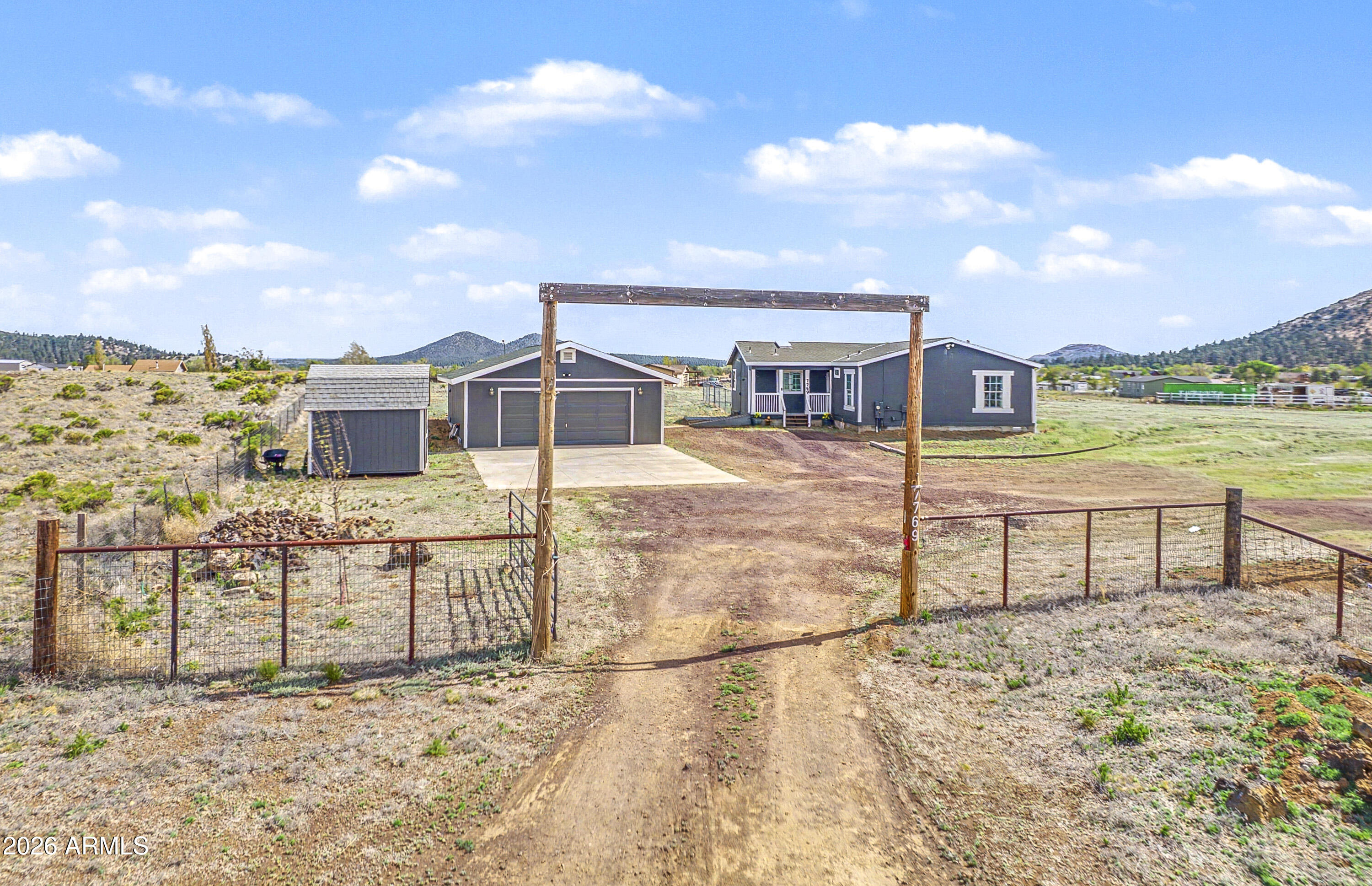 Wake up to wide-open skies, panoramic mountain views, and the peace of rural living in this private, fully fenced modular mountain retreat. Featuring A/C, 3 bedrooms, 2 baths, a SEPARATE OFFICE, and a BONUS ROOM, this home offers space, flexibility & comfort. The open great room & dining area showcase vaulted ceilings, LVP flooring, a newer pellet stove, abundant natural light & floor-to-ceiling windows framing stunning views of the SAN FRANCISCO PEAKS. The spacious kitchen features a large island, skylight, butcher block countertops, breakfast bar, and eat-in dining area. Enjoy a split floor plan with a spacious primary suite, ensuite bath, jetted tub, and separate shower. Complete with a 4-car garage/workshop, sheds, 2 RV hookups, filtration system, fire pit, and room for ATVs, RVs, horses, chickens & more. Mountain living w/room to grow!