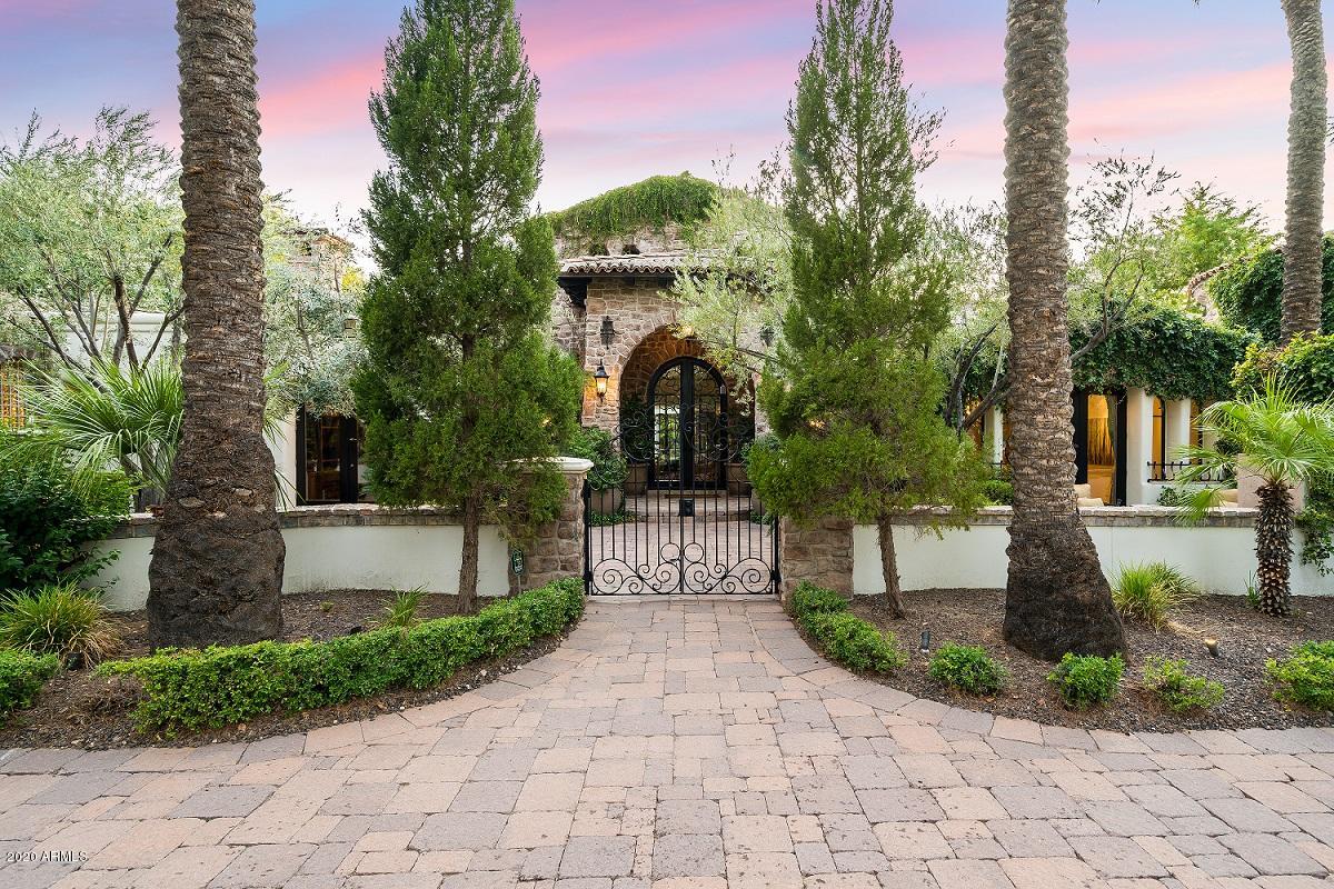 Located on over an acre in the highly sought after neighborhood of Paradise Valley Farms, this remarkable Tuscan estate was featured in both Phoenix Home & Garden and Sunset magazines. You won't believe the resort like feel this home offers on the interior & exterior with landscaping designed by award winning designer Greg Trutza (Royal Palms Resort). This lush design is an entertainer's dream featuring a chef's kitchen, custom-cabinetry, stone floors, Venetian plaster & many other fine finishes. Offering four en suite bedrooms, a den, sports lounge & fitness room, the fine lifestyle continues outside with a dream yard offering many different destination points & private patios, courtyards & venues including a 5-star resort pool & spa with a swim-up bar & cabana.
