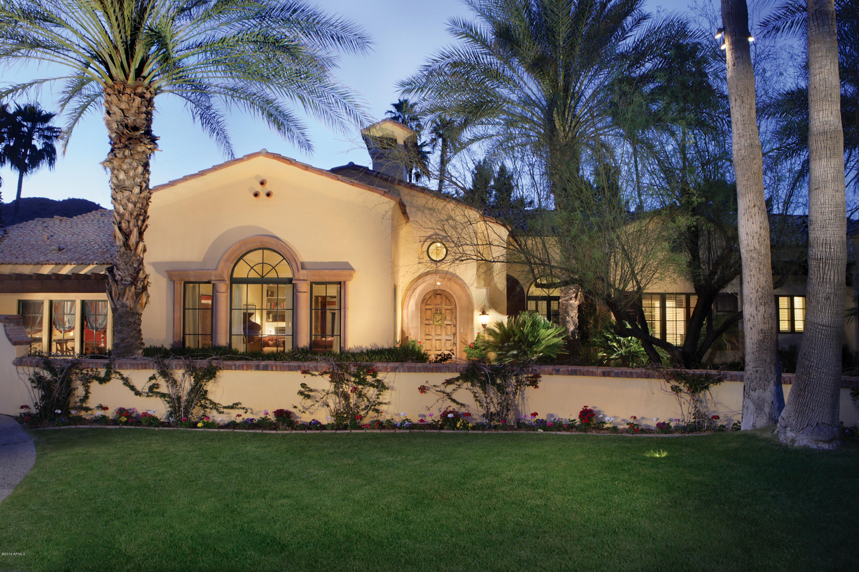 Santa Barbara inspired, Candelaria designed remodel on the golf course at Paradise Valley Country Club. Charmingly warm and cheerful with 6 bedrooms, 4.5 baths, tennis court and pool all in a setting surrounded by golf course and mountain views on highly desired Eucalyptus Drive. Creative detail displayed with architecturally significant ceilings, arched hallways and Craftsman Court custom tile. Kitchen is a chef’s delight trimmed in Blue Bahia granite with antique center island, 2 dishwashers, Sub-Zero, Viking range and barreled ceiling with up lighting ambiance, opening to family room. Great floor plan with study room area. 
Master has generous built-ins, huge walk in closet and Carrara marble bath room. Separate guest wing and media room. Premium PV location. Landscaping by Berghoff.