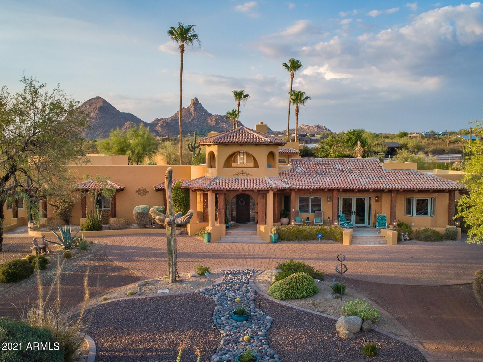Space! Views! Income potential! Welcome to Tranquility Trail – a retreat that facilitates peaceful living yet offers amazing entertainment space and easy access to all the amenities of North Scottsdale.  Meticulously remodeled in 2019 by Argue Custom Homes, this 4,927 sf south-facing home, plus 1,250 square foot 2 bed / 2 bath guest home (total combined is 6,177sf), sits on a 5-acre horse property. The kitchen features a spectacular 16-foot-long Brazilian tourmaline island that seats up to 10 people, along with beautiful custom cabinets and Thermidor appliances, including a steam oven. The large walk-in pantry has ample custom cabinet space and a second refrigerator and washer and dryer. The spacious master bedroom has dual closets and bathrooms and includes a 2-seated bathtub and...MORE a roomy walk-in shower with multiple showerheads. This fabulous suite walks out onto a large wrap-around porch with views of the rose garden, pool, and beautiful Pinnacle Peak beyond. The sitting area has a cozy gas fire with a wine bar and the great room features a bar, skylights and custom furniture that perfectly suit the space (available on a separate bill of sale). Other fabulous amenities include a dog run, 2-car garage, multiple car ports, two viewing decks with stunning 360-degree views from both the main residence and the guesthouse, workshop, BBQ, outdoor half bath, 2 outdoor fire pits and a sport court that could be transformed into whatever your heart desires  in the past it has been the site of many parties, family gatherings and even a wedding  and the figure 8 entry drive ensures there isn't a traffic jam! There is so much to see and do on this breathtaking property (walking, hiking, cycling), it is a must-see to fully appreciate all of the unique comforts it has to offer!