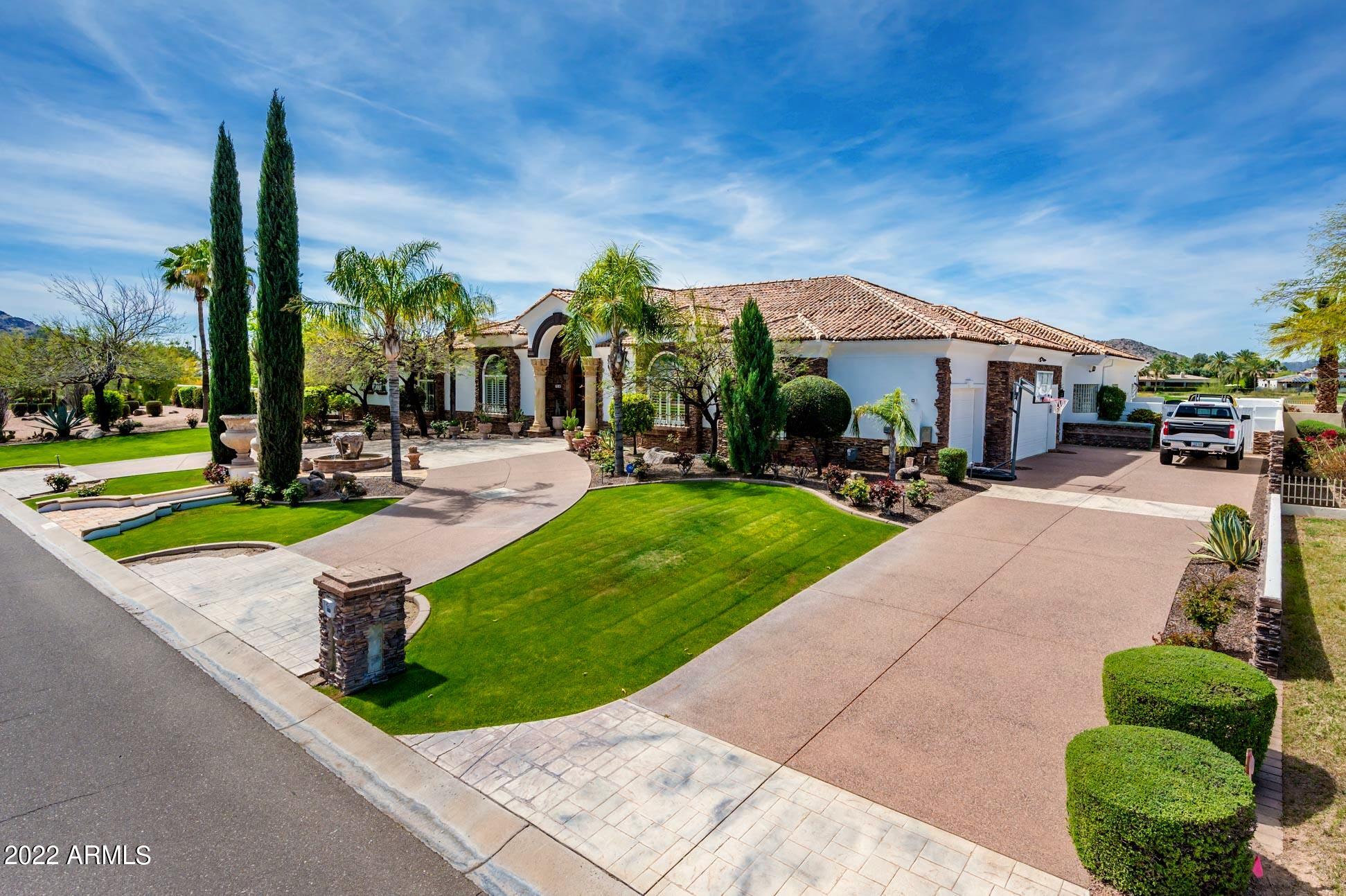 With immediate occupancy on the 8th Green and 9th Tee box is this incredible pond with dock + boat amenities Residence. Jaw dropping panoramic sweeping views of the Phoenix Preserve plus Mummy Mountains on 1.61 acres. The grounds are lush, on a quiet Cul-De-Sac street, offering like a resort setting yard, pool, spa and a portable equipped grass tennis court. All your everyday room needs to include an oversized primary bedroom live on the main level. Every room offers views, secondary bedrooms plus a second Laundry set up down bellow; Elevator shaft is in place for a quick install.