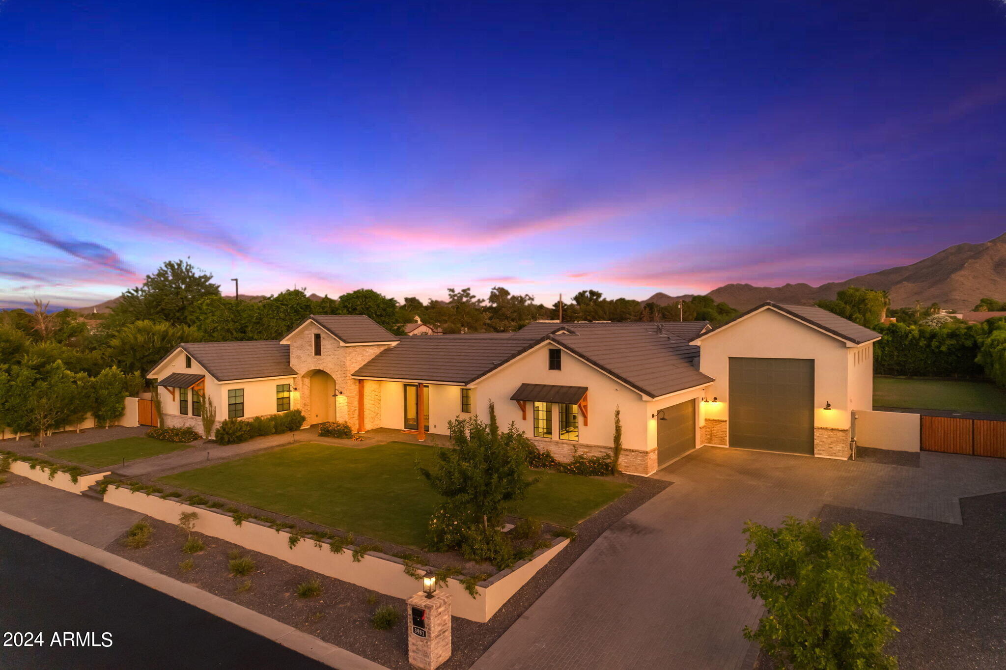 Experience the epitome of luxury living in this incredible home, offering over 5,600 square feet of space. Located in the prestigious gated community of San Tan Lakeside Estates, this property includes a casita, an RV garage, and a heated pool with a swim-up bar. Nestled in a stunning ski lake community, it boasts multi-million dollar custom homes and breathtaking mountain views. Ensuring complete privacy, a $100,000 mature ficus hedge surrounds the entire property. The backyard is an entertainer's dream, featuring three in-ground trampolines, a fireplace, and a swim-up bar. Misters encircle the entire house, including the casita and courtyard, providing a cooler outdoor environment. The large drive-through RV/boat garage is ideal for storing your boat or RV.