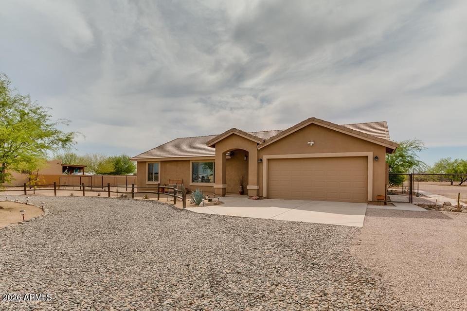 EXCELLENT LOCATION, HORSE PROPERTY, NO HOA!  Don't miss this nicely updated 3BD 2BA, split floor plan property.  Located  20 minutes from Surprise one direction and Wickenburg the other.  This home features a great kitchen with stainless appliances, a great room and dining area with wonderful natural lighting.  Guest BD are spacious and the primary bedroom features a nice walk-in closet and spacious bath.  
Enjoy the back fully covered patio, separately fenced yard/patio from the remaining yard that is fully fenced and features horse shade(s).  There is also a nice shed that makes a great tack room.  This home also features easy care landscape so if you happen to be a winter only visitor, you can leave with no worries.  Roof was completely replaced in 2026.