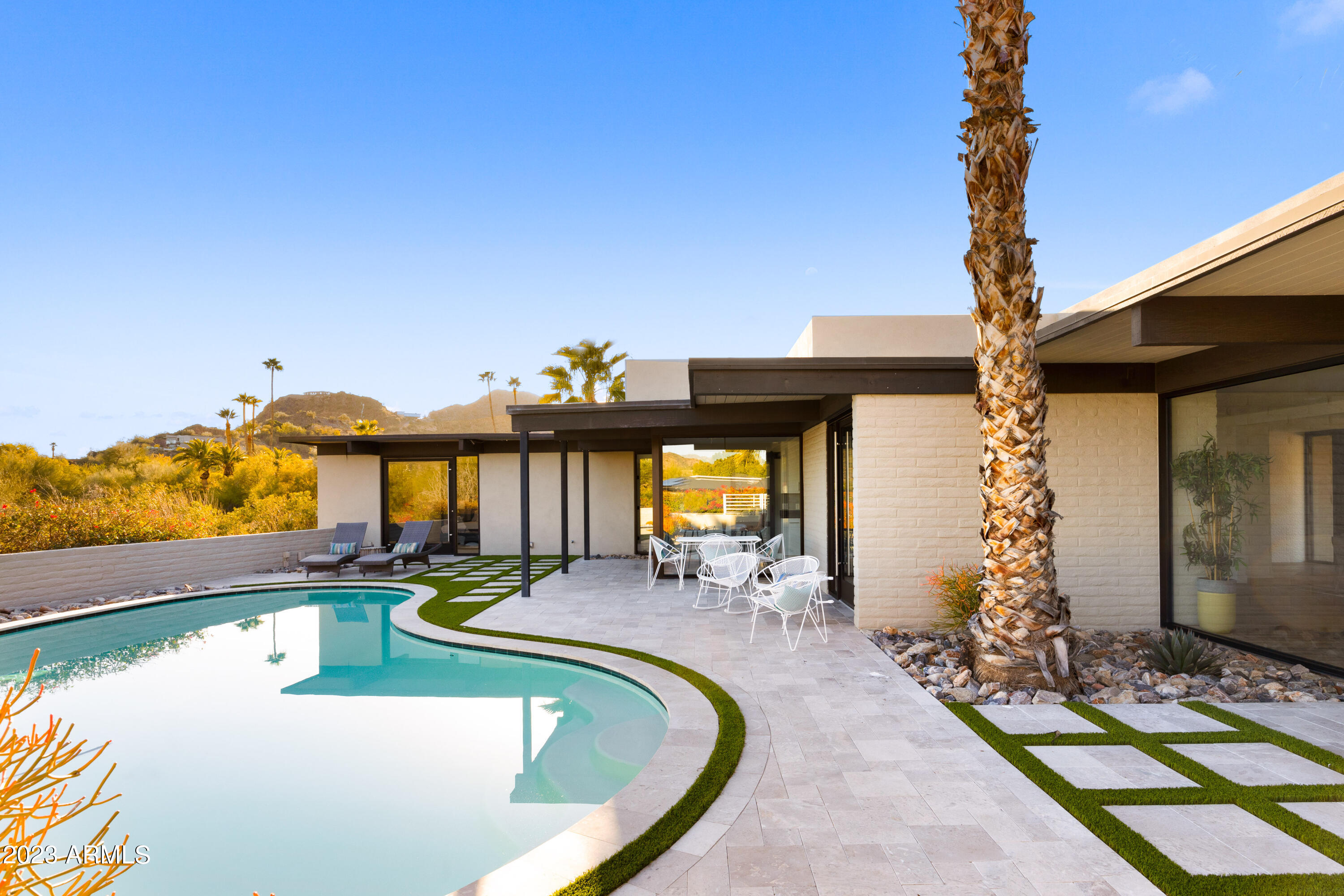 Come see this exceptional, mid-century modern, home in the heart of the highly sought-after, guard gated, community of Clearwater Hills. Fully remodeled in 2019 with contemporary touches to complement the architecture and kept in pristine condition since. Incredible mountain views surround the home from every angle with Camelback Mountain framed as the center point from all the main living areas. Every room features floor to ceiling windows, letting in natural light from sunrise to sunset. Set up as a perfect lock and leave home with 4 bedrooms, 3 and a half bathrooms, and a large bonus room separate from the main living space. At just under an acre, the lot spans the whole corner of Lakeside Ln and Clearwater Parkway providing for options to expand the living quarters or to add a garage.
