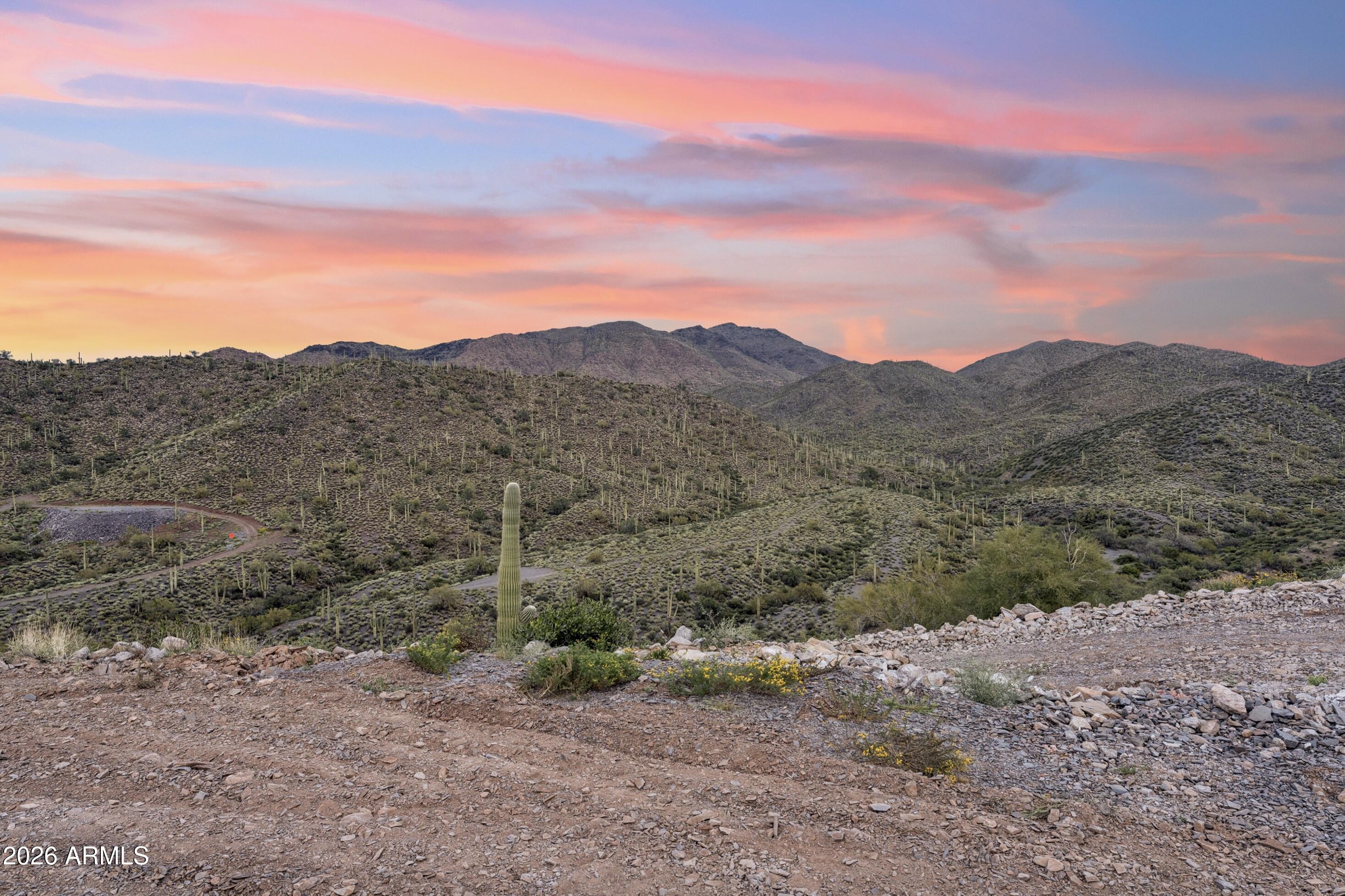 INCREDIBLE PANORAMIC VIEWS!! Breathtaking Landscapes as far as the eye can see! Nestled in the prestigious high desert area in Cave Creek, this rare, 4.99 acre property offers privacy and one of the areas most spectacular custom home settings. Extraordinary hilltop homesite, with phenomenal views in every direction!  Unobstructed pristine desert views, glorious sunsets and captivating mountain ranges, including views of Elephant Mountain, Black Mountain, Gold Mountain, and the surrounding Continental Mountain range. Perched high above the exclusive surrounding luxury community.  This property has so much to offer and is an exceptional find!  Seller has invested heavily in many site improvements already; excavation, grading, pad compaction, driveway work, slope engineering certificate, plus, soil and perc tests have been completed, simplifying your building process and time! R-190 rural zoning with the distinct advantage of a Cave Creek address, but with Maricopa County taxes and zoning for more build flexibility, fewer restrictions and No HOA. 

Primary building pad is engineered for approx. 5000 sq ft home. The secondary pad is ready for a casita to be built, or barn, garage, or equestrian set up. Complete your luxury sanctuary with your dream home; build to capture iconic desert views, awe-inspiring sunsets, dramatic mountain views in every direction, and distant, sparkling city lights and enjoy stunning 360 views, while witnessing the magic of nature, every single day, morning and night! 

Property is adjacent to the distinguished luxury new home community of Continental Mountain Estates, where prestigious 5+ acre estate homes, designed and built by the award winning BedBrock Development are selling at $10million and above.  This is a great time to purchase a build ready lot in this area, and a must see property for the spectacular views alone!  

Incredibly scenic area with mature saguaro forest, lush desert vegetation and stunning mountain peaks. Enjoy year-round access to hiking, biking, horseback riding, and trails. Just minutes to downtown Cave Creek and quick access to Scottsdale and everything the North Valley has to offer. 

Check out aerial drone video in the MLS to experience the views, privacy and potential of this exquisite property.