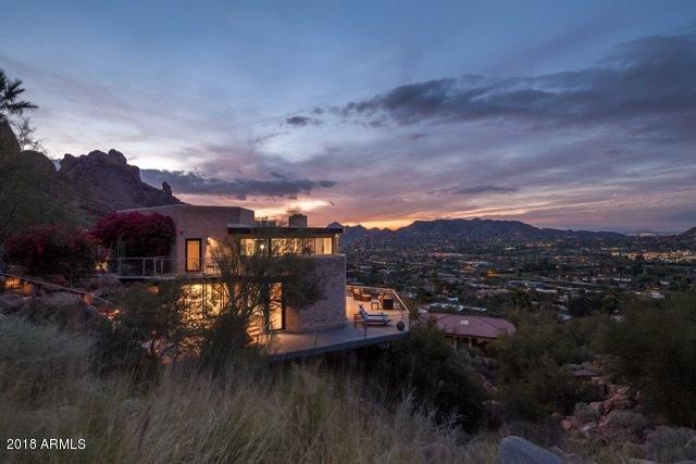 Camelback Mountain views in a private sleek modern contemporary sitting high within the world famous Sanctuary Resort! Open floor plan with views of Paradise Valley County Club, the Praying Monk & city lights. Low maintenance living with extraordinary finishes: Finecraft rift cut cabinetry, Turkish stone floors, black honed countertops & more. Decks and patios to enjoy dramatic vistas, (3) fireplaces, from the collaborative works of D. Dick Architect/MAK Construction (home rebuilt from original slab in 2012)/De la Torre Design Studio, NYC. Tremendous investment opportunity as part of Sanctuary Resort. 2-car garage and pool photos are visual renderings.