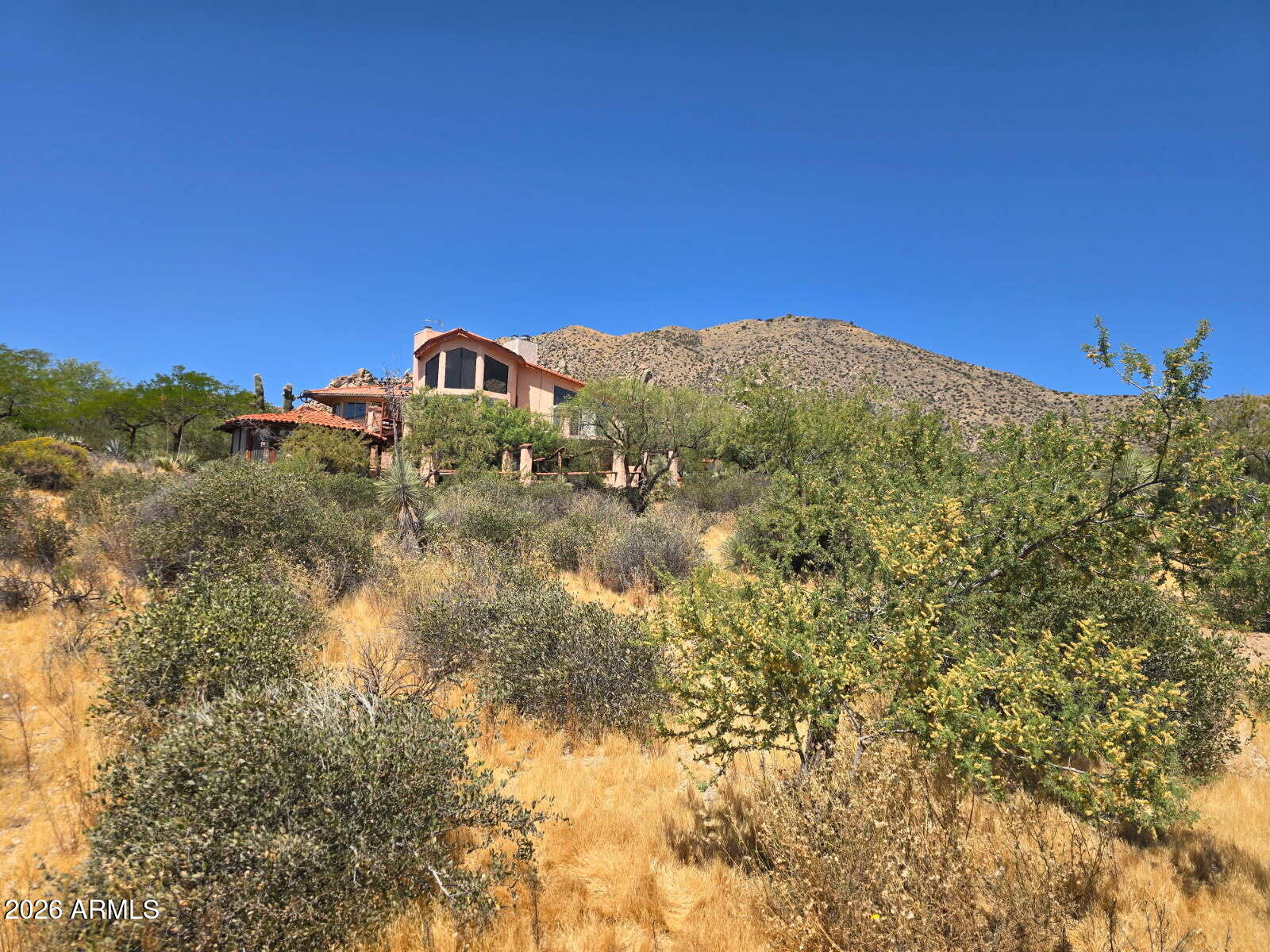 VIEWS, VIEWS VIEWS from one of the highest lots in the Tonto Hills at  apprx. 3500 ft elevation!  360 degree views include Four Peaks, Weaver's Needle, Superstitions, & the boulder laden mountainside of Apache Peak. Whether you are looking to take advantage of the current structure and available materials (uninstalled newer windows, flooring included) or remove the current home and build your own vision, this higher elevation location is rare. Temperatures are consistently 10-15 degrees cooler than the valley. Tonto Hills has the unique world's largest concrete kachina at its entrance, home to the famous Raven's View Wine Bar. Located in unincorporated Maricopa County w/ a THIA (Tonto Hills Improvement Association) You'll be singing ''I can see for miles and miles'' after your visit here.