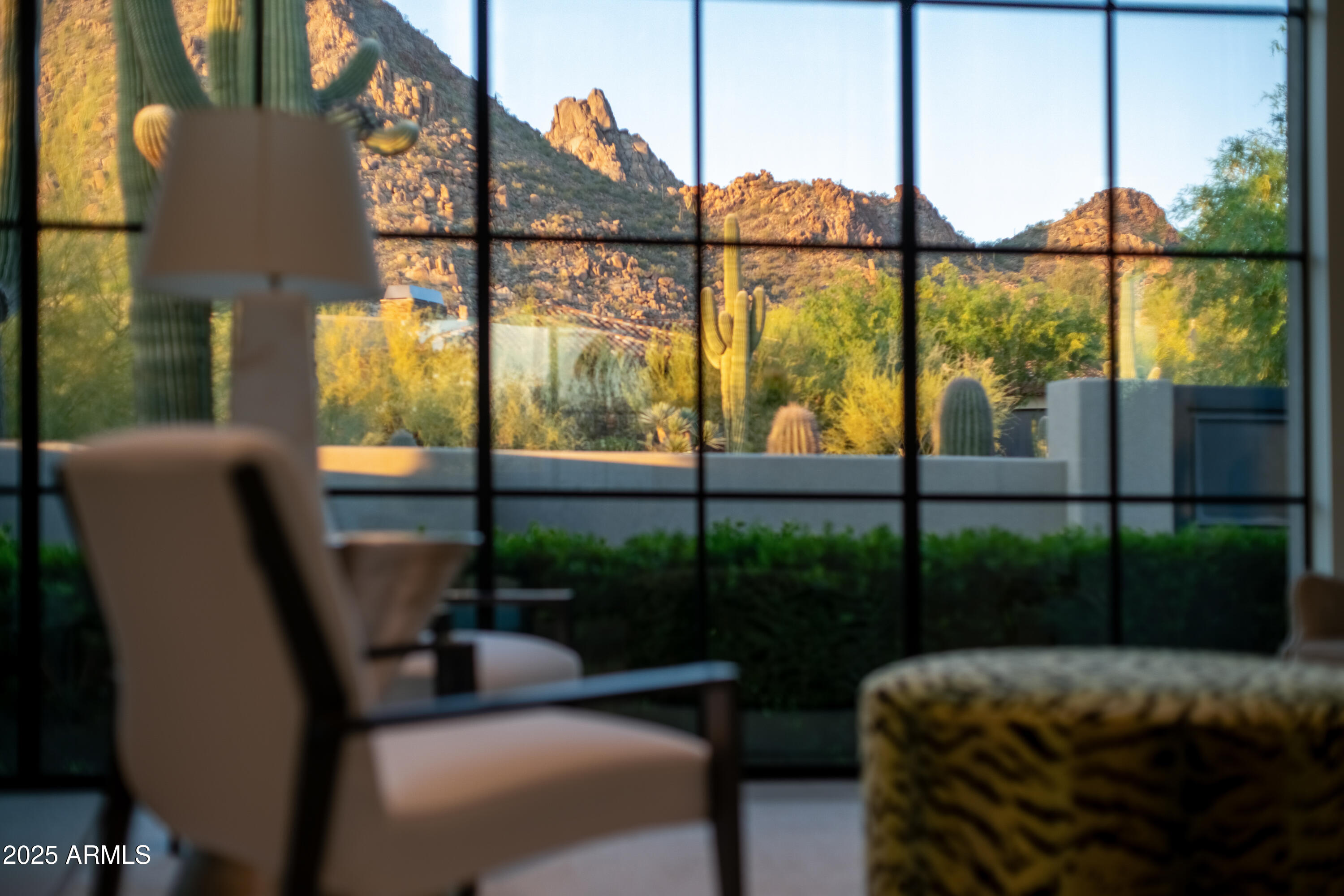 Nestled on 1.435 acres within the prestigious guard-gated community of Desert Highlands, this rare architectural masterpiece was thoughtfully envisioned by its owner and brought to life by renowned G&T Custom Homes. Blending modern sophistication with the natural beauty of the Sonoran Desert, this single-level residence with NO INTERIOR STEPS offers walls of glass that frame dramatic views of Pinnacle Peak. Sleek interiors, open living spaces, and refined finishes create a seamless balance of elegance and comfort. Designed for both intimate living and effortless entertaining, the home features three ensuite bedrooms in the main residence and a private casita complete with one bedroom, one bath, and a kitchenette. With a seamless indoor-outdoor connection, the home lives as both an entertainer's dream and a private sanctuary, thoughtfully crafted to embrace the desert lifestyle. Within this exclusive community, residents enjoy the rare advantage of immediate golf membership and access to the newly reimagined Jack Nicklaus Signature Golf Course, thoughtfully redesigned and restored to enhance play and experience. Elevated amenities, including new women's locker rooms and a refined pro shop, further enrich the world-class lifestyle of Desert Highlands.