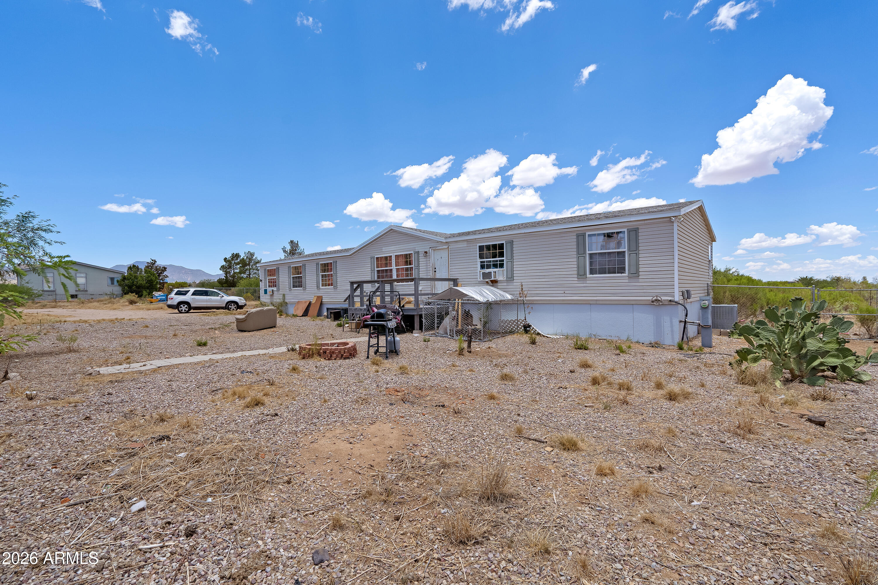 Investor Opportunity! Bring your vision and unlock the potential of this spacious 2,240 sq. ft. home situated on 1.93 fully fenced and gated acres of horse property. Featuring 4 generously sized bedrooms, 2 bathrooms, and a desirable split floor plan, this home offers two bright and spacious living areas, a cozy fireplace, an eat-in kitchen with a separate dining area, and a dedicated laundry room.

The primary suite includes dual sinks, a large soaking tub, and a separate shower. Additional features include dual-pane windows throughout, central air conditioning, an architectural shingle roof, front and back decks, and a storage shed.

Conveniently located with paved road access to within approximately 45 feet of the entrance, this property offers privacy, room to roam, and breathtakin mountain views. Whether you're looking for your next investment, renovation project, or a property with endless potential, this is an opportunity you won't want to miss. Home Starts here!
