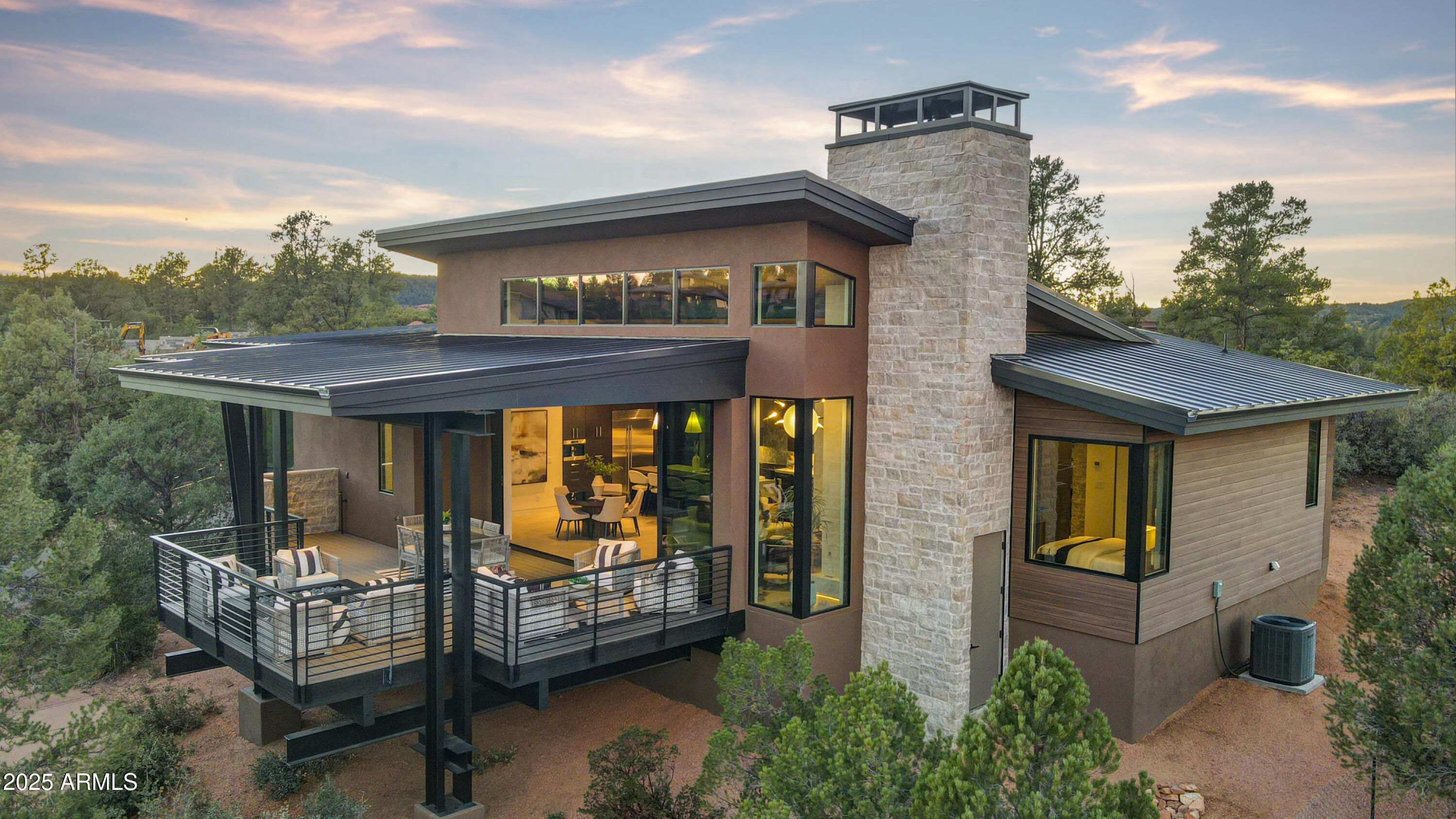 Move-In Ready Fully Furnished Modern Mountain Retreat in The Rim Golf Club Experience effortless luxury in this 2,288 sq. ft. single-level, 3-bedroom, 3-bathroom residence nestled within the exclusive gates of The Rim Golf Club. This move-in ready, fully furnished model home combines modern mountain architecture with the highest level of craftsmanship and design. Positioned in one of the most unique settings within the community, this home offers the rare opportunity to participate in Integra's exclusive Stay & Play rental program, professionally managed in partnership with The Rim Golf Club, the only program of its kind available in either The Rim or Chaparral Pines. Designed for true lock-and-leave living, the exterior features maintenance-free TimberTech siding, a standing seam metal roof, and authentic stonework. Step inside to discover an elegant, open floor plan filled with natural light from clerestory windows and a 20-foot wall of glass that seamlessly connects indoor and outdoor living spaces, framing breathtaking mountain views. The chef's kitchen is equipped with Wolf and Sub-Zero appliances, including a built-in coffee system, and a stunning island ideal for entertaining. Additional features include steel interior and exterior beams, 36'' x 36'' large-format tile flooring, Pella windows, Lutron smart lighting, RING security system, and full SMART home automation. Outdoors, a spacious covered patio and built-in firepit area (gas line pre-installed) provide the perfect setting to enjoy cool mountain evenings. Every element of this home showcases the finest materials and technology available in luxury construction today.