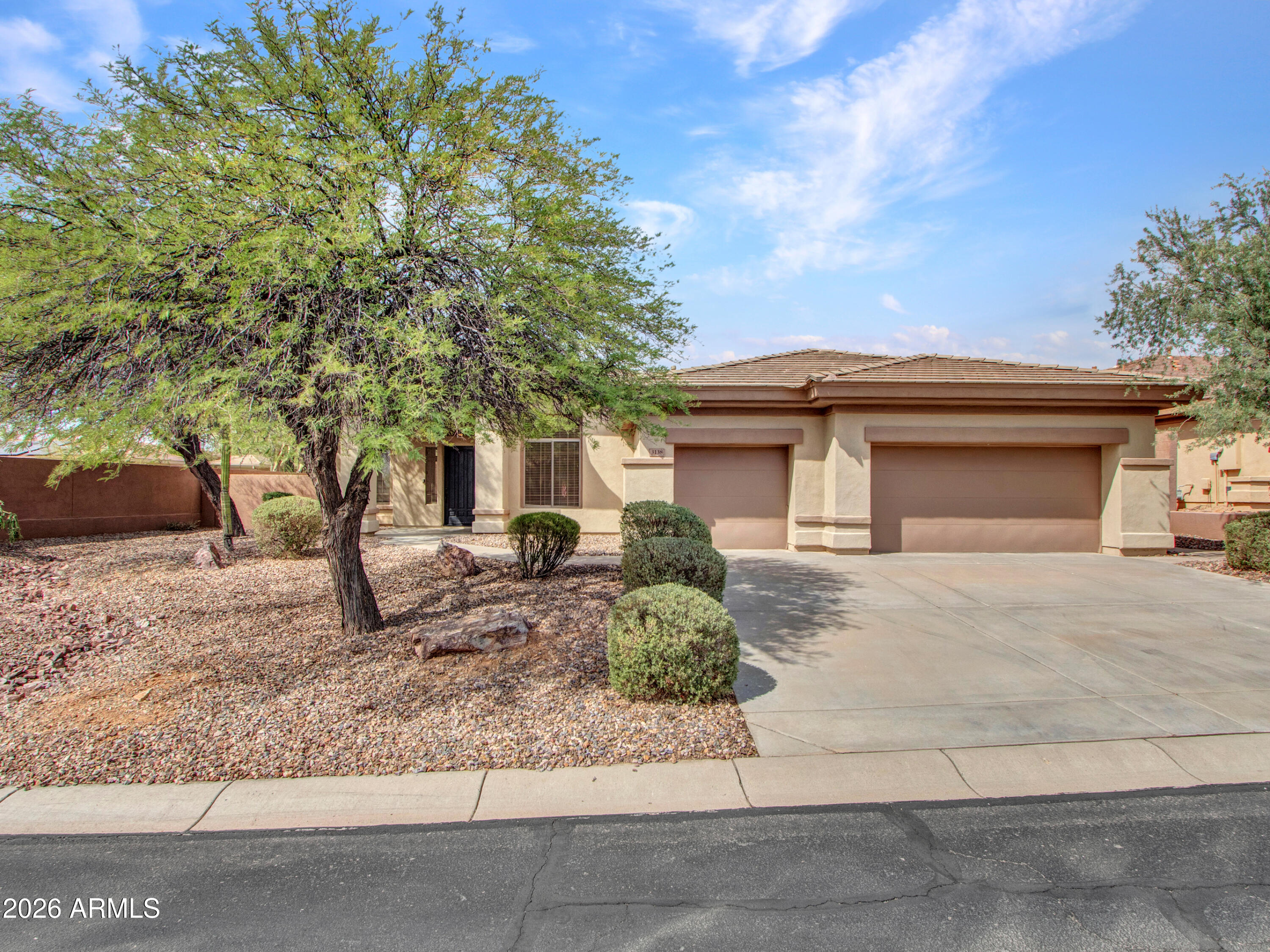 Experience refined desert living in the prestigious gated community of Anthem Golf & Country Club. Situated on a premium north/south-facing corner lot spanning over 12,000 square feet, this beautifully updated Bennington model offers 2,542 square feet of thoughtfully designed living space with 3 spacious bedrooms, each featuring its own private en-suite bath, plus a convenient powder room.
From the moment you enter, soaring ceilings, abundant natural light, elegant marble tile flooring, and a dramatic floor-to-ceiling stacked stone fireplace create a warm yet sophisticated atmosphere. The updated kitchen is both stylish and functional, featuring crisp white cabinetry, stainless steel appliances, a new gas cooktop, updated lighting, breakfast bar seating, and a casual dining area. MORE area perfect for everyday living and entertaining.
The private primary retreat offers a spa-inspired bath complete with dual vanities, a soaking tub, glass-enclosed shower, and generous walk-in closet. Recent improvements include a new roof, fresh interior paint, and numerous updates throughout, making this home truly move-in ready.
Step outside to enjoy Arizona's year-round outdoor lifestyle with a large covered patio, raised entertaining area, low-maintenance synthetic turf, and expansive yard space. The oversized 3-car garage features epoxy flooring and its own dedicated air-conditioning unit.
Residents enjoy world-class amenities including two championship golf courses, resort-style pools, fitness centers, tennis and pickleball courts, dining venues, social clubs, and 24-hour guarded gate security. Conveniently located near shopping, dining, recreation, and easy access to I-17, this exceptional home offers the perfect blend of luxury, comfort, and the resort lifestyle that makes Anthem Country Club one of North Phoenix's most desirable communities.