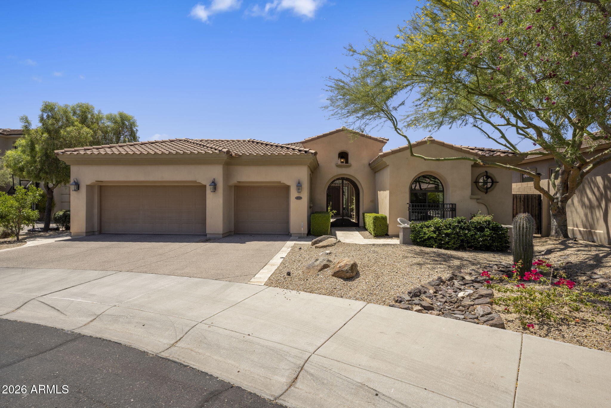 WOW! What a show stopper. Beautifully appointed home with all the right colors and upgrades and backs to a large wash. Mountain views out front and City lights out back. Incredible floor plan has Primary Suite, 2 guest rooms and office downstairs plus an attached guest casita on the first level. The second level has a loft, bedroom, full bath and a huge game/flex room (could be converted to another bedroom with a smaller game room). Kitchen is open to family room with a 24 ft sliding glass door to the stunning entertainers rear yard. There is a dining room as you enter that is currently being used as a billiard room. Upstairs you will find a balcony to enjoy sunsets and city light views. The balcony is also accessible by a spiral staircase off rear of home. Control 4 system is included.