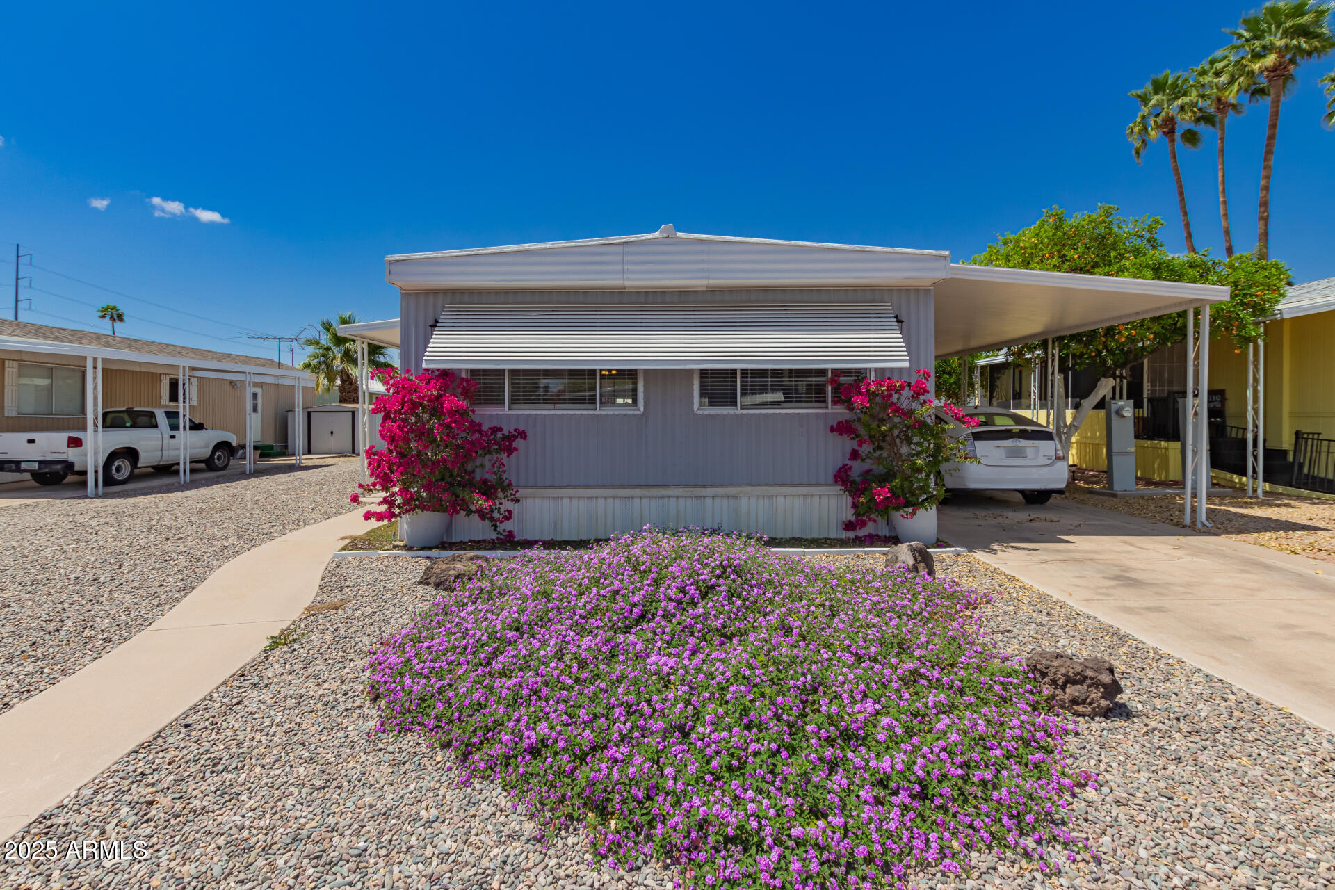 Welcome to this charming 2-bedroom, 2-bath mobile home in the 55+ Friendly Village of Orangewood! Discover an appealing open layout with a soothing palette, recessed lighting, blinds, and wood-look flooring for a timeless appeal. The well-appointed kitchen has crisp white shaker cabinets, a tile backsplash, stainless steel appliances, and a peninsula with a breakfast bar for casual meals. The main bedroom offers ample closet space and a private bathroom for added convenience. Outside, you'll find a covered patio, a storage shed, and a mature citrus tree that adds Mediterranean charm. The Community includes a golf course, a recreation center, a refreshing pool, and well-maintained amenities.